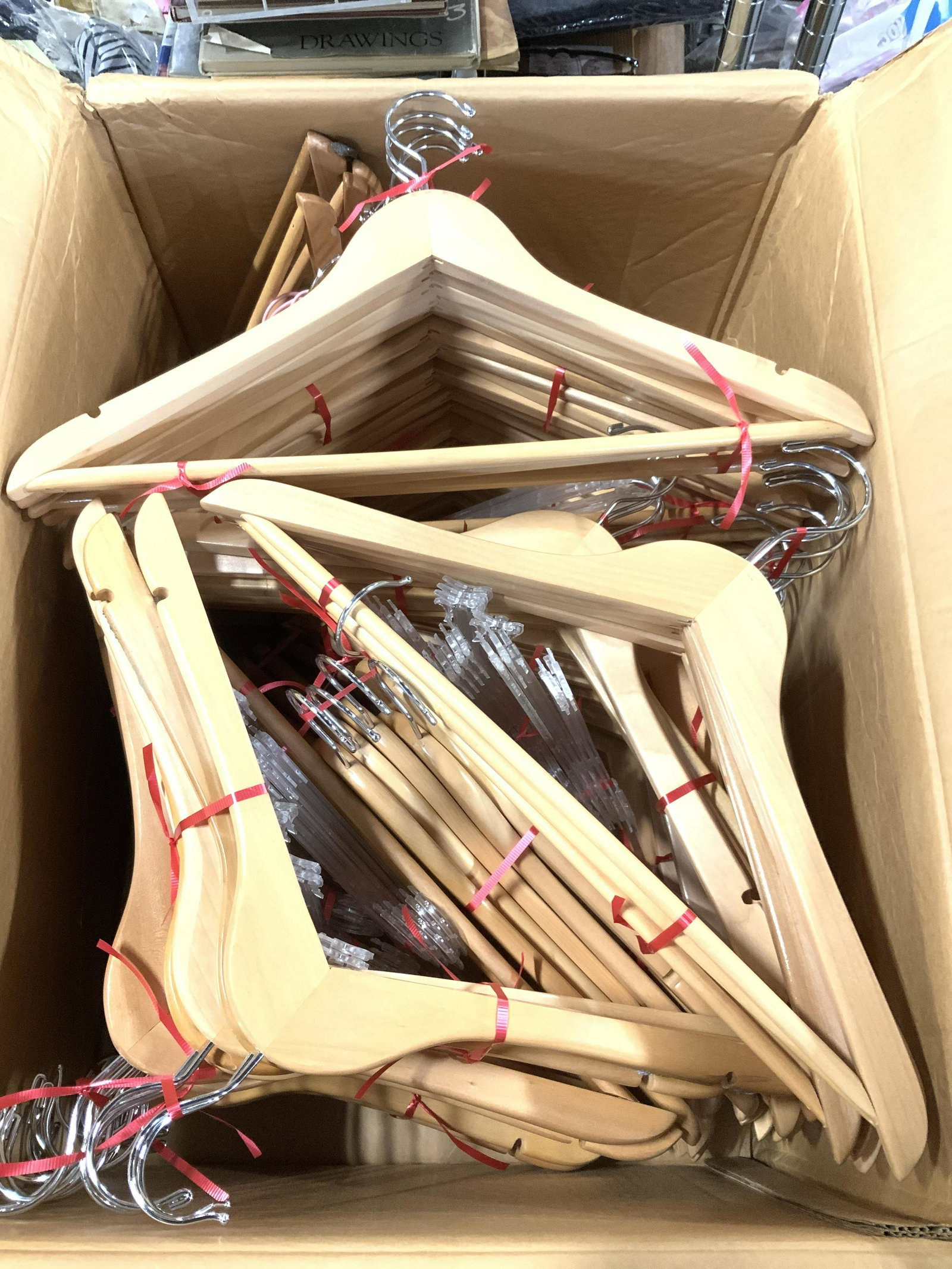 Box of Solid Wood Hangers , new: Maple wood hangers and plastic lingerie hangers, over 60 wood hangers, 40 lingerie hangers and some children/ baby size wood and pink coated wire hangers. New or lightly used in large box. Wood hanger
