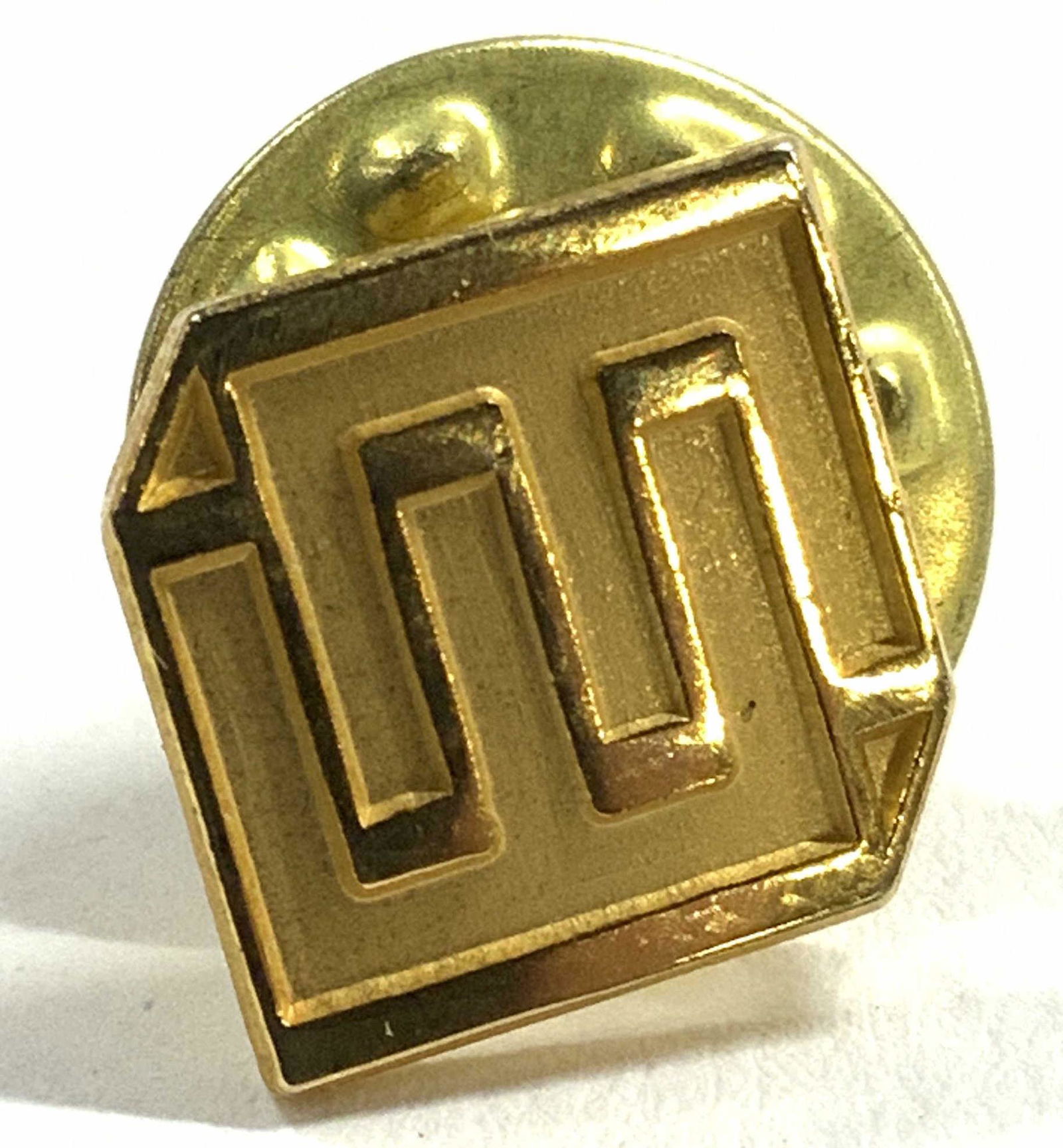 Vintage Geometric Pin Gold Toned: Pin is vintage. Piece has geometric detail. Pin is gold toned. Piece measures approx .45 inches square. Pin, vintage pin, geometric pin, fashion accessories. 6