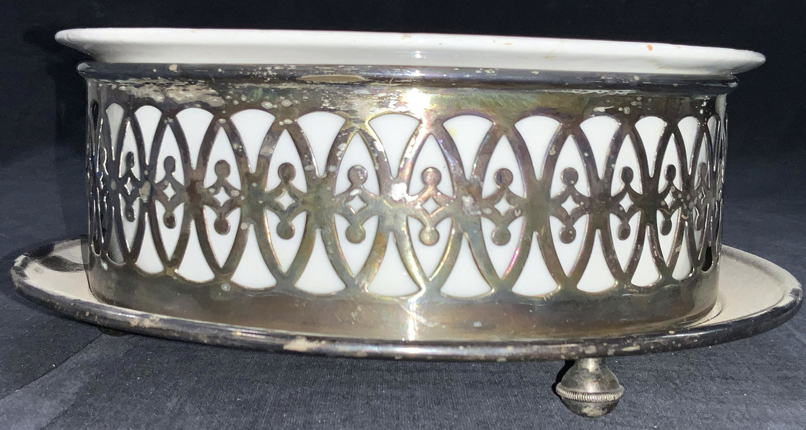 Vintage Sterling Trivet W Porcelain Insert: Vintage sterling trivet with removable porcelain insert. Trivet has cut walls with ornate patterns. Trivet tested positive for sterling silver using Puritest metal tester. Approximately 3.5 inches tal
