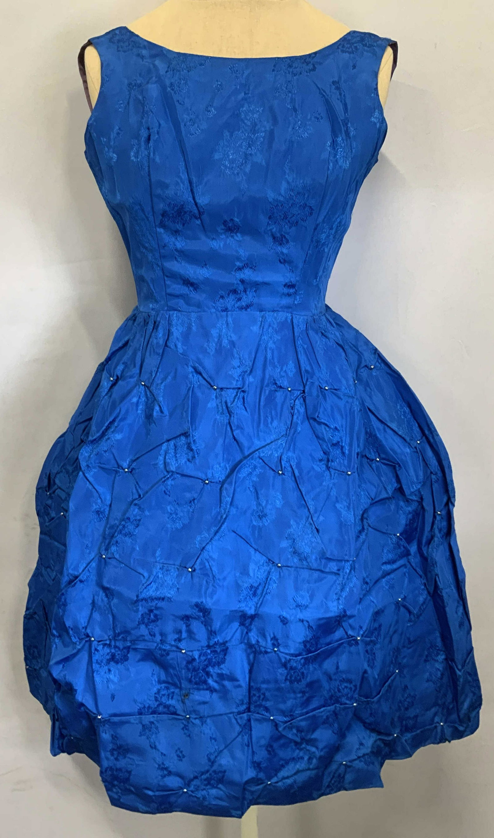 Vintage Blue Floral Embroidered & Beaded Dress: A vintage custom made sleeveless midi dress with floral embroidery and beaded decoration in blue. Hidden back zipper. Possibly taffeta. Measures approx. 14.5 inches across chest and 11.5 inches across