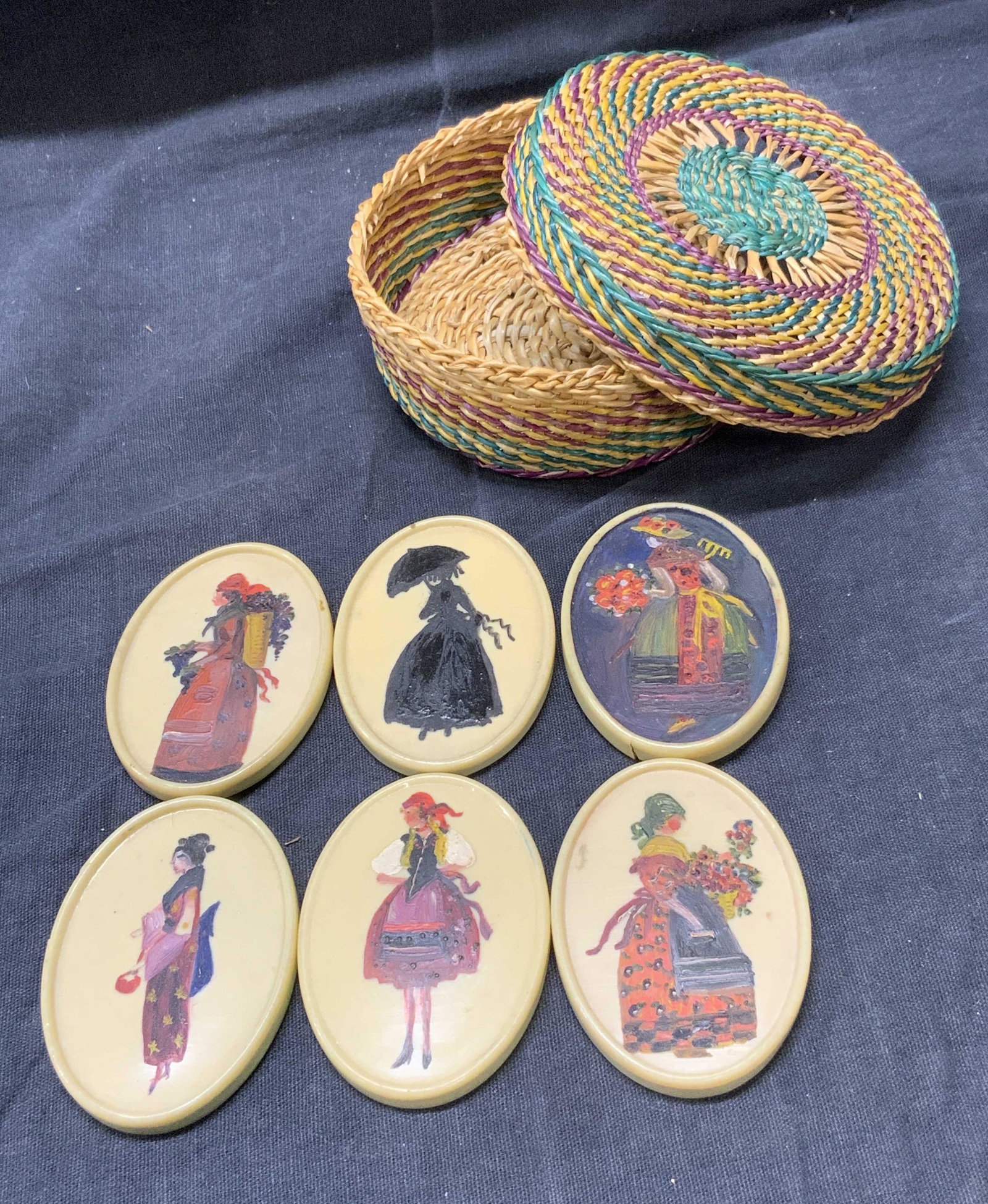 Wicker Trinket Vessel With Hand Painted Mirrors: Lidded Wicker Trinket Vessel With Hand Painted Compact Mirrors, includes 6 mirrors, each has hand painted woman on verso, 1/6 is missing the mirror glass, circular wicker trinket box measures approx 3