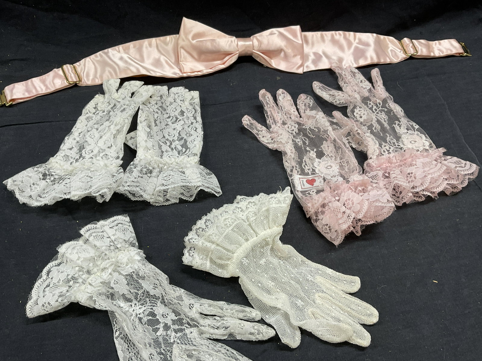 Lot Vintage Lace Fashion Accessories and Wearables: Lot Vintage Lace Wearables. 2 pairs of lace gloves, pink and white and 2 lace gloves that dont have any pairs. Pink bow accessories. Minimal wear. 1 fingerless pair of lace gloves. Lace gloves. Pink b