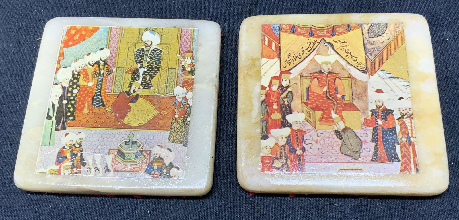 Pair Natural Stone Islamic Painting Motif Coasters: Pair Natural Stone Islamic Miniature Painting Motif Coasters with glaze topcoat, each with unique Islamic miniature subject, verso with affixed felt, each measure approx 3 x 3 in. Surface wear. Pair N