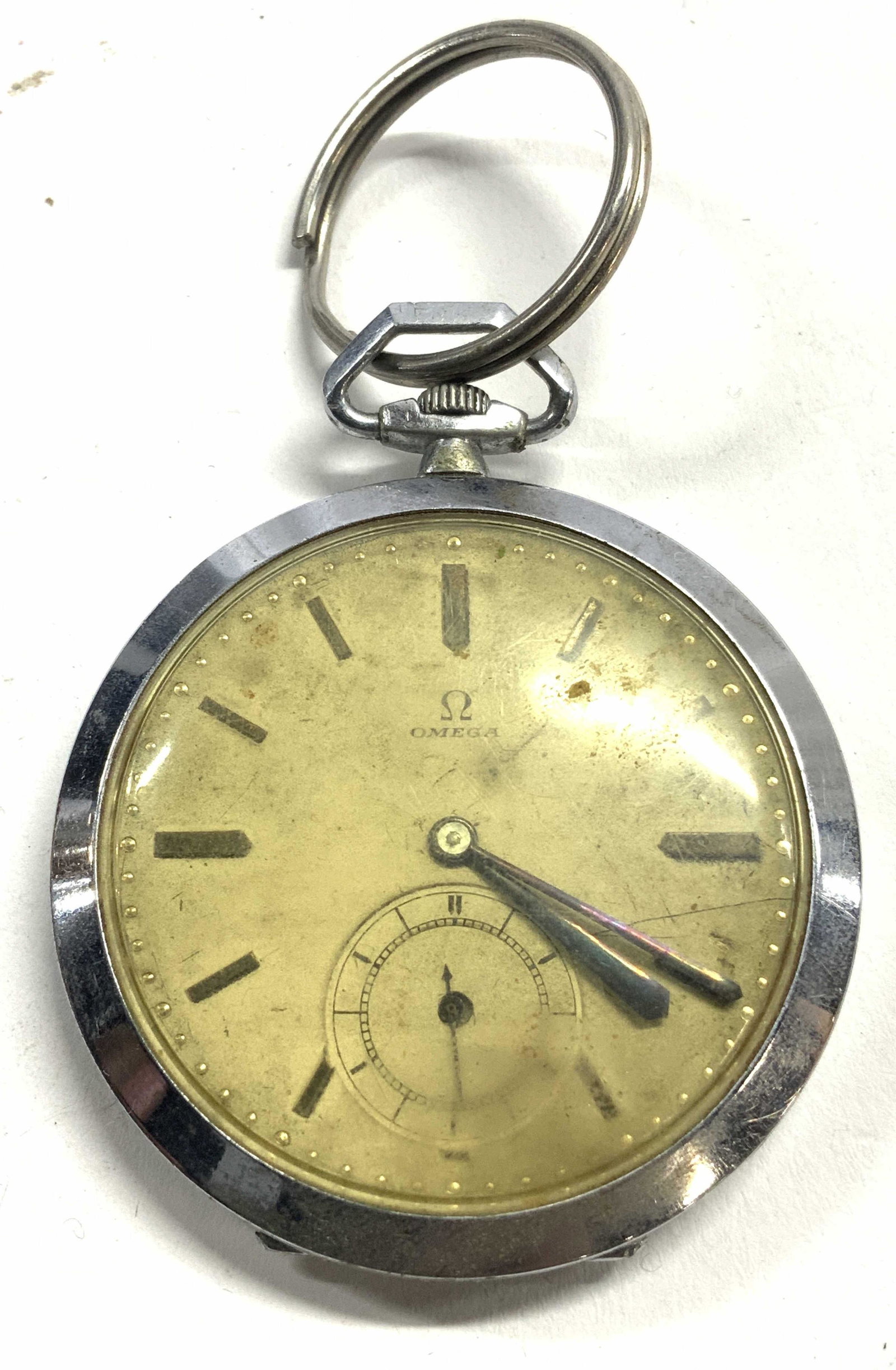 OMEGA Pocket Watch: Watch face is gold toned & reads OMEGA. Piece has silver toned metal edges. Piece measures approx 3 inches tall with key ring, 1.75 inches wide. Pocket watch, omega watch, omega pocket watch, vintage 