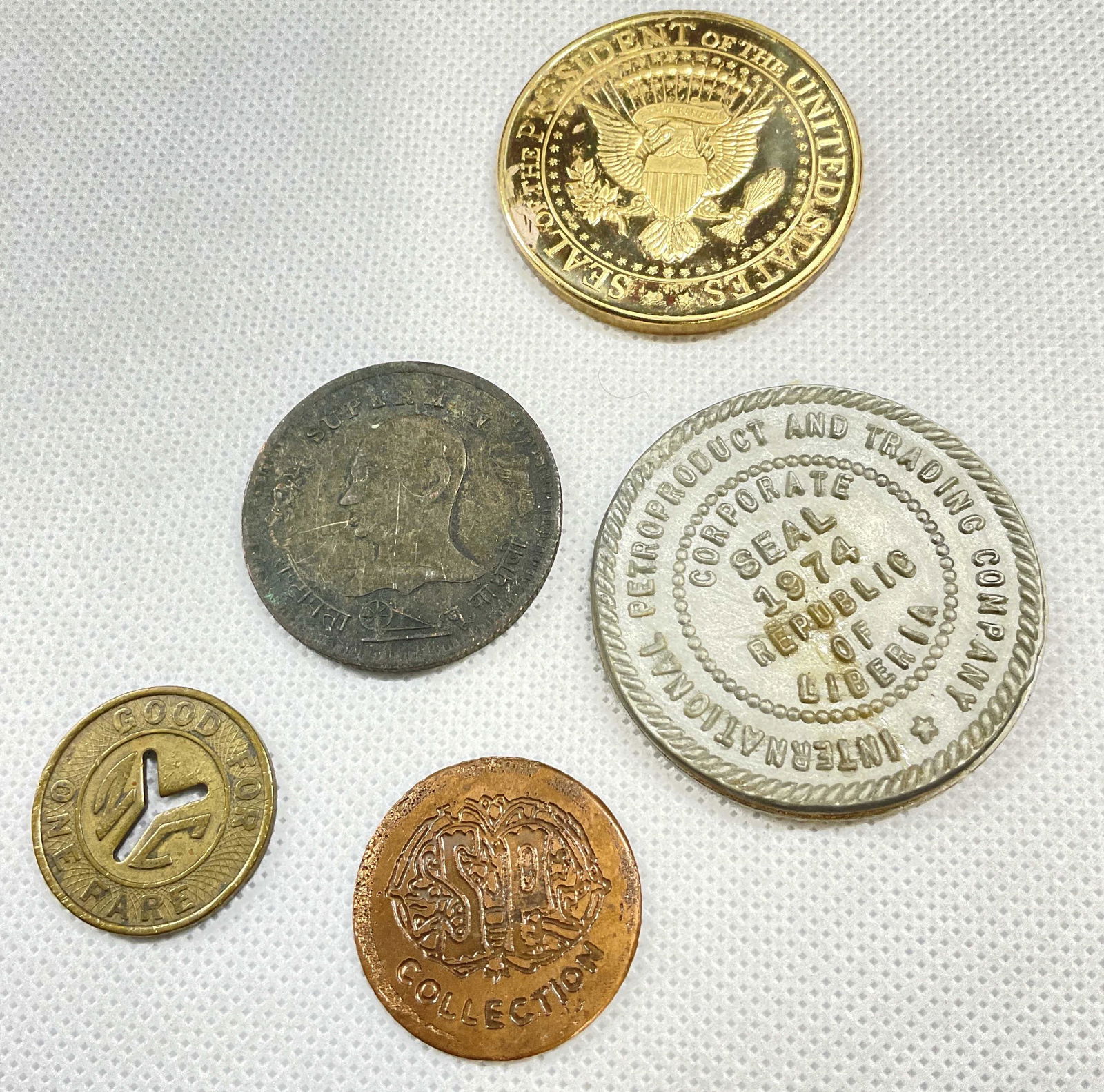 Lot 5 Collectible Coins: Lot 5 Collectible Coins. Coins include a Trump Coin, a antique NYC Transit Coin & more. Coins surface wear consistent with age and use. Collectible coins, coins, antique coins, nyc transit coin, Trump