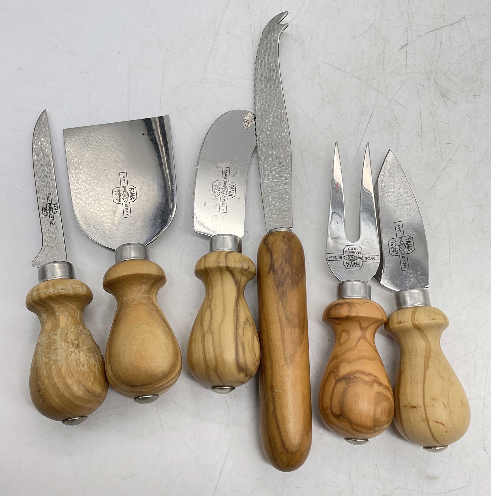 Set 6 FAMA Cheese Knives, Italy: Set 6 Fama Cheese Knives, marked on steel Fama, made in Italy, Maniago Inox. Wear to pieces consistent with use. Cheese knife, FAMA cheese knives, made in Italy, charcuterie accessories, Chisel Knife,