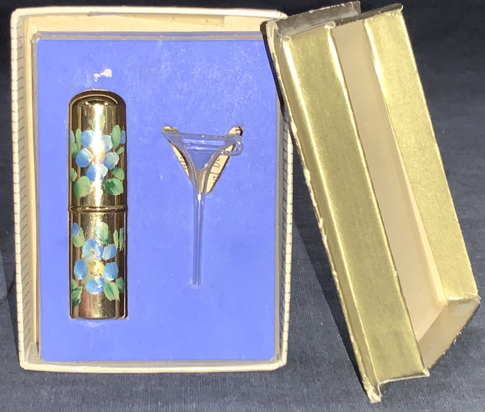 KORY Hand Painted Perfume Pen W Box: Hand painted perfume pen with funnel, in box. Perfume pen is brass made with hand painted blue flowers with glass bottle, marked Kory on underside of pen and box. Comes in gold toned lidded box. Pen i