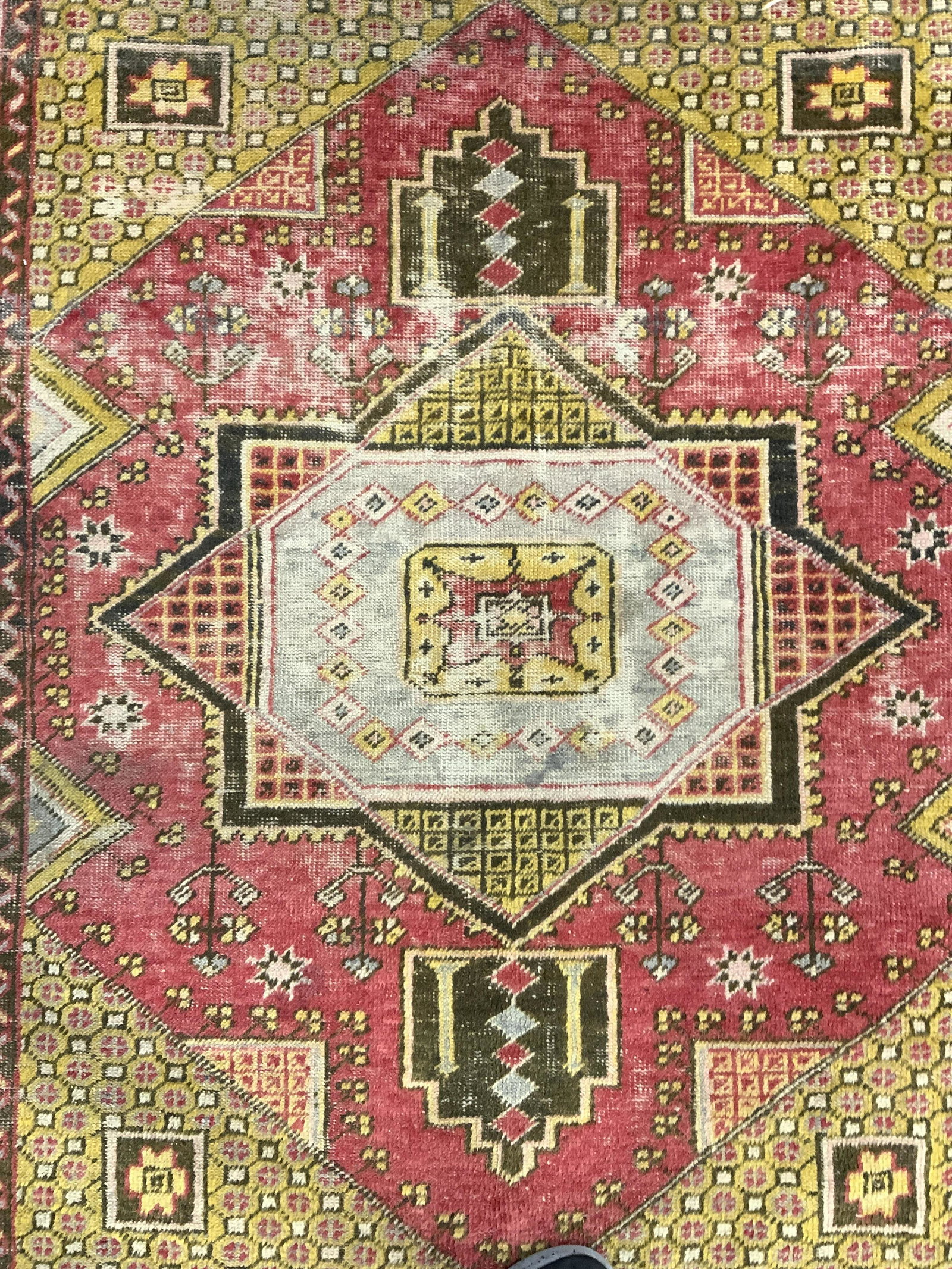 Vintage Handmade Turkish Wool Area Rug: Rug is vintage possibly antique. Piece is handmade and wool. Rug has short fringes. Piece has intricate multi toned geometric detail. Piece measures approx 72 inches long 53 inches wide. Rug, carpet, 