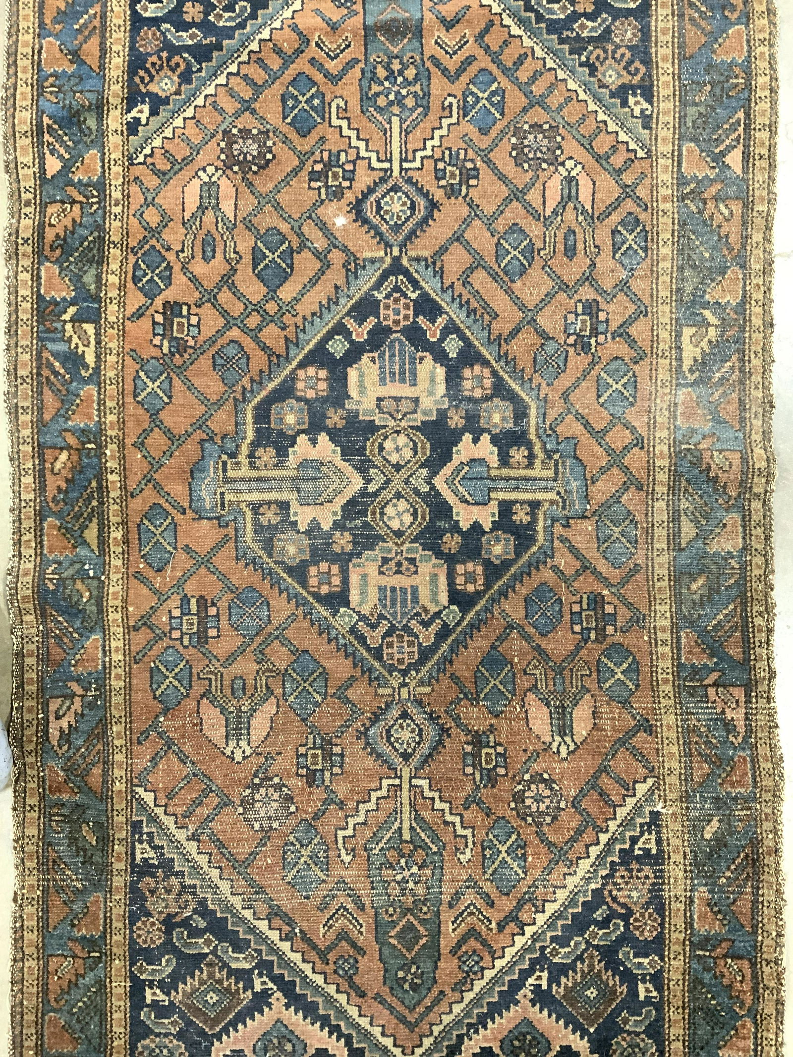 Vintage Handmade Persian Wool Area Rug: Rug is handmade and wool. Piece is vintage possibly antique. Rug appears to be Persian. Piece has some short fringes. Rug measures approx 75 inches long 39 inches wide. Rug, carpet, wool rug, vintage
