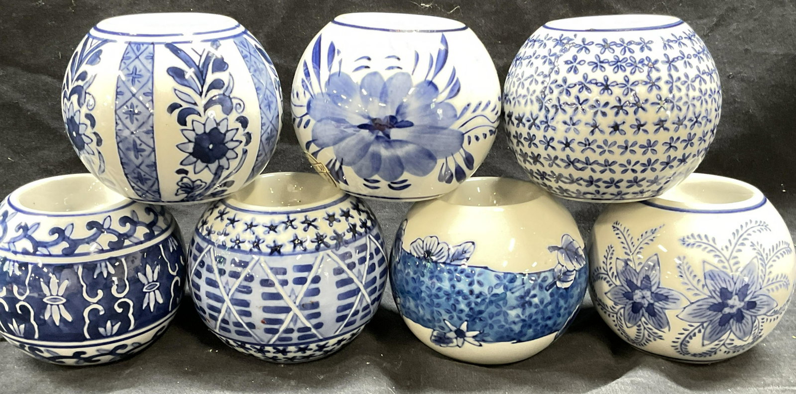 7 Blue & White Votive Candle Holders: 7 Blue & White Votive Candle Holders. All glazed differently. Fits am inch wide votive candle. Pieces measures approx 3.5 x 3 inches. Votive candle holders, blue & white candle holders, floral detaile