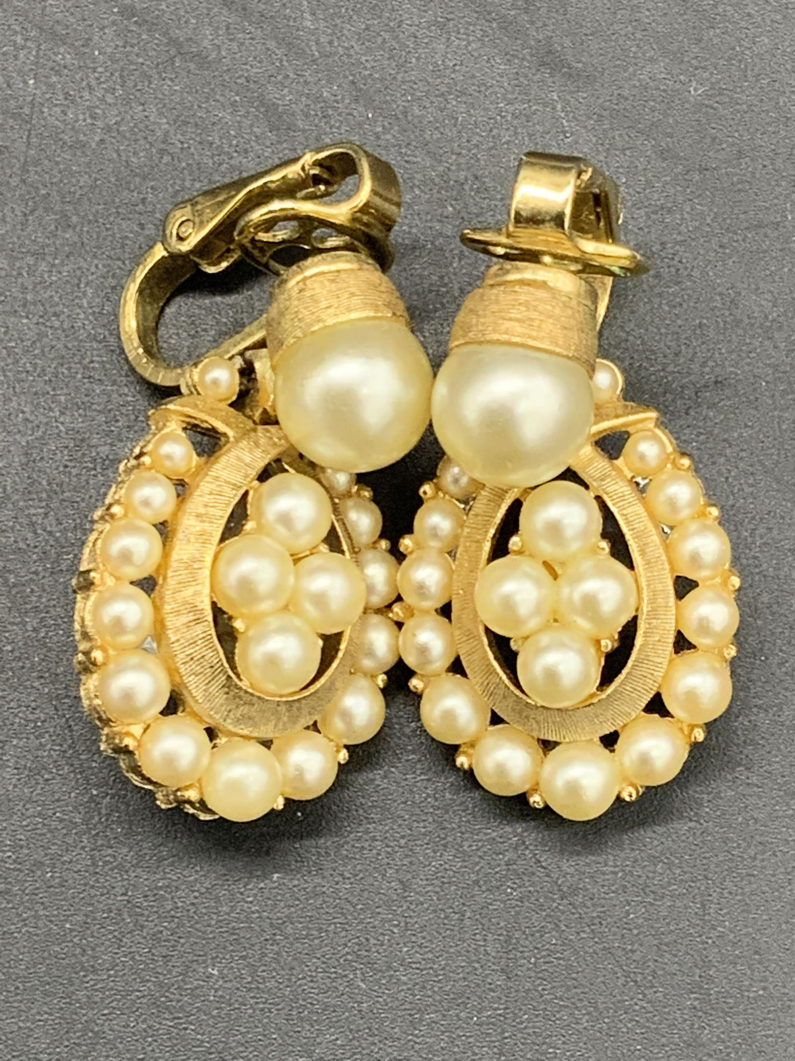 TRIFARI Vintage Pearlescent Drop Earrings, Jewelry: Vintage gold tone metal drop earrings featuring pearlescent beads. Signed Trifari on clip on earring backs. Measures approx 1L x .5W in. Some wear consistent with use and age. Vintage jewelry, Vintage