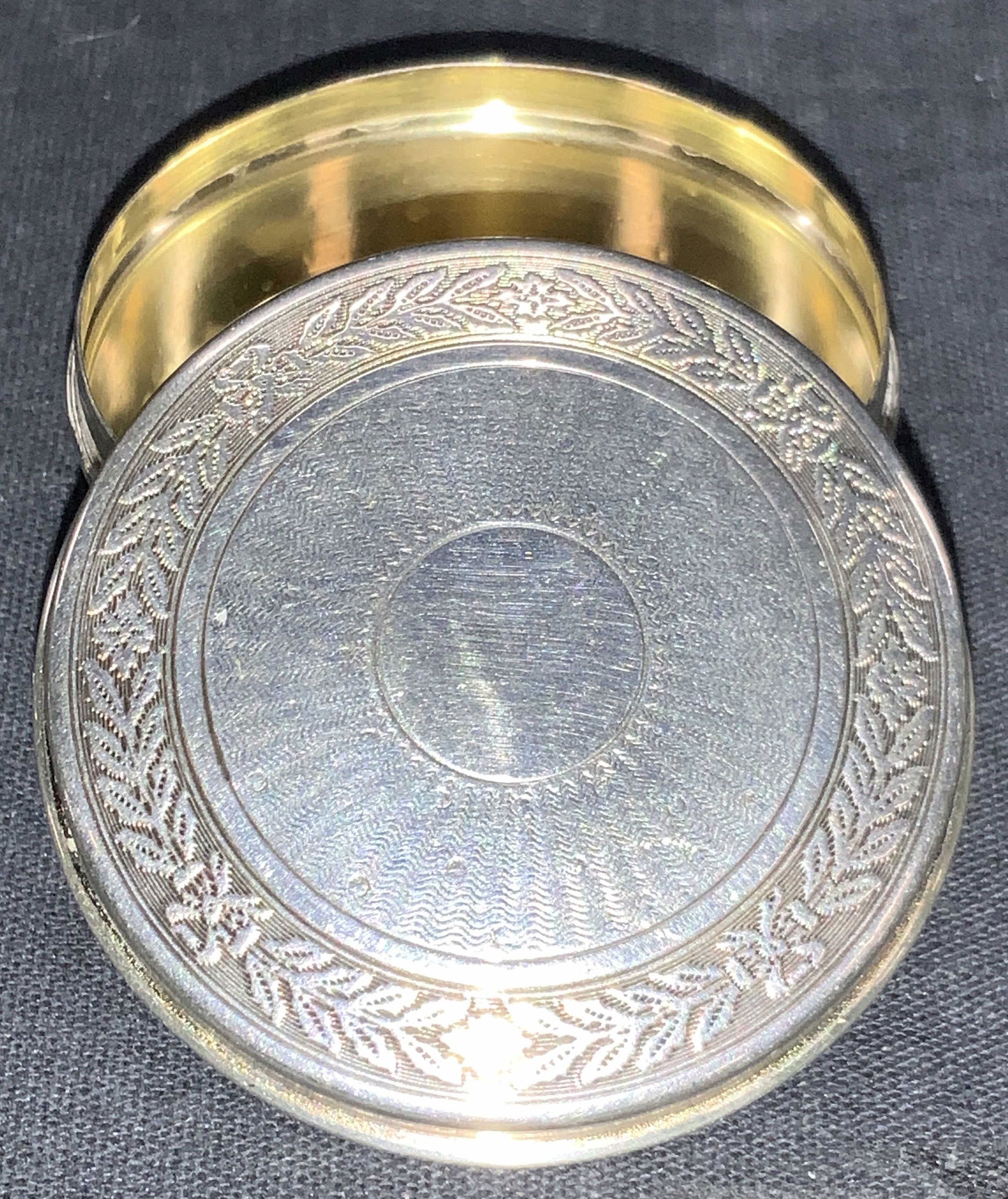 Vintage Sterling Etched Hallmarked Pill Box: Vintage etched pill box, hallmark on edges illegibly. Lid is etched with floral reefs near dredges and center sun burst with body and underside having waved etchings. Tested positive for sterling usin