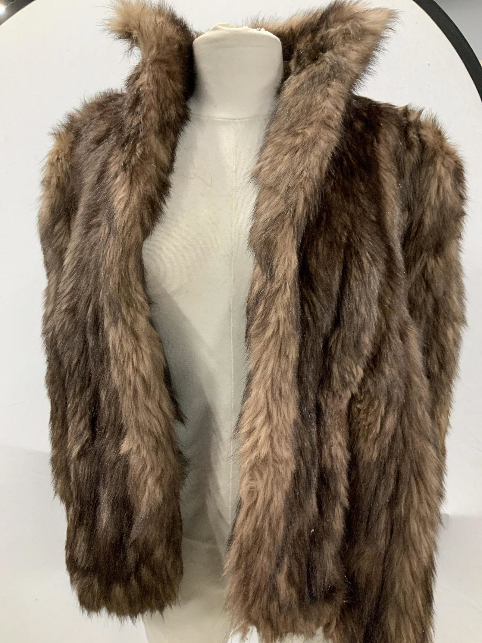 Unlabeled Custom Made Thick Fur Lined Vest: This garment works as a vest, but has a cape - like style with low pass through arms. . High collar, lined interior ( which has some discoloration from use). Fur possible dyed raccoon. Thick fur. App 