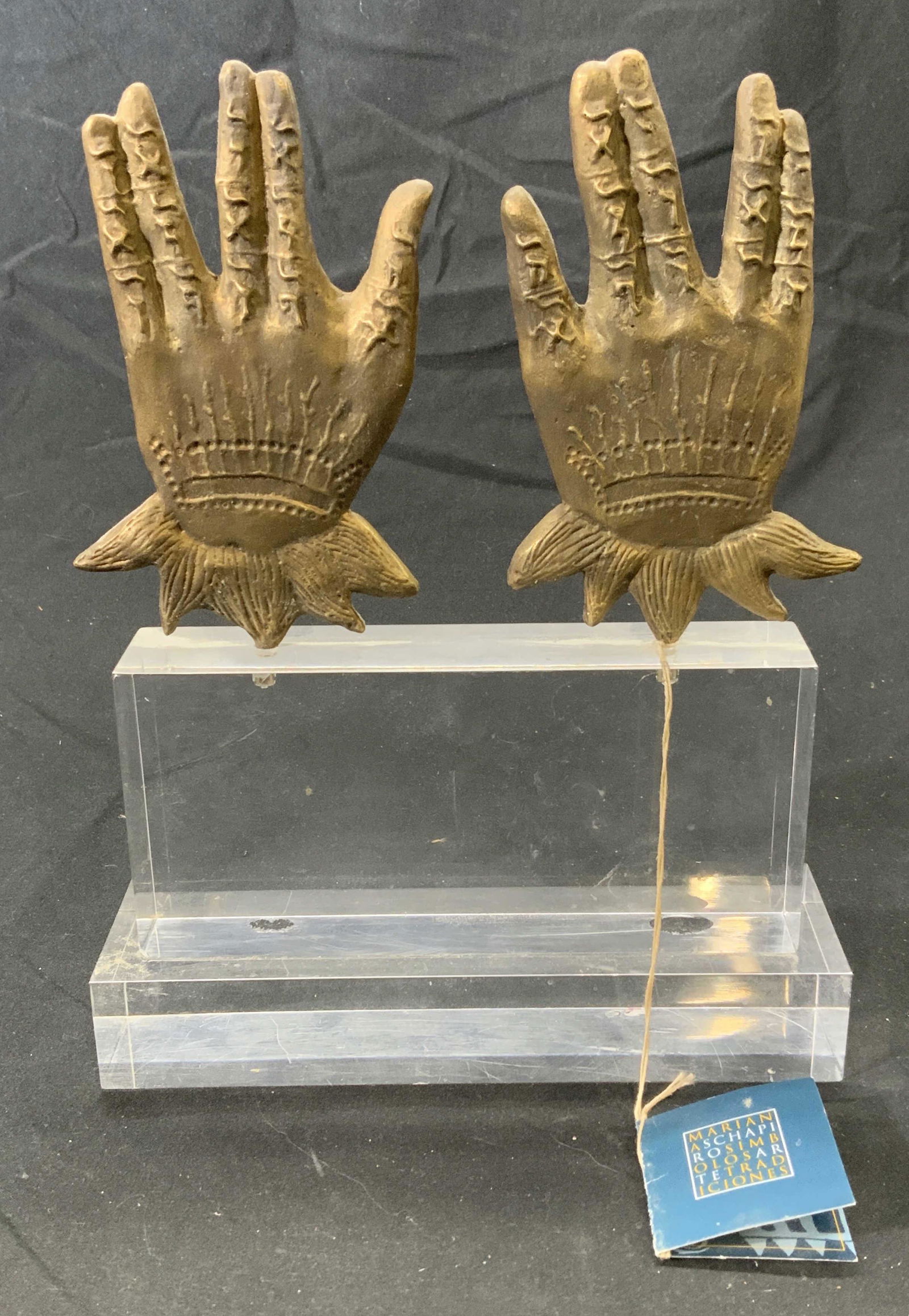 MARIANA SCHAPIRO Lucite & Brass Sculpture: Mariana Schapiro lucite and brass hand form sculpture. Embossed brass on transparent lucite pedestal. Includes certificate of authenticity. Measures approx. 6.75 x 2 x 8.75 inches. Some surface wear c