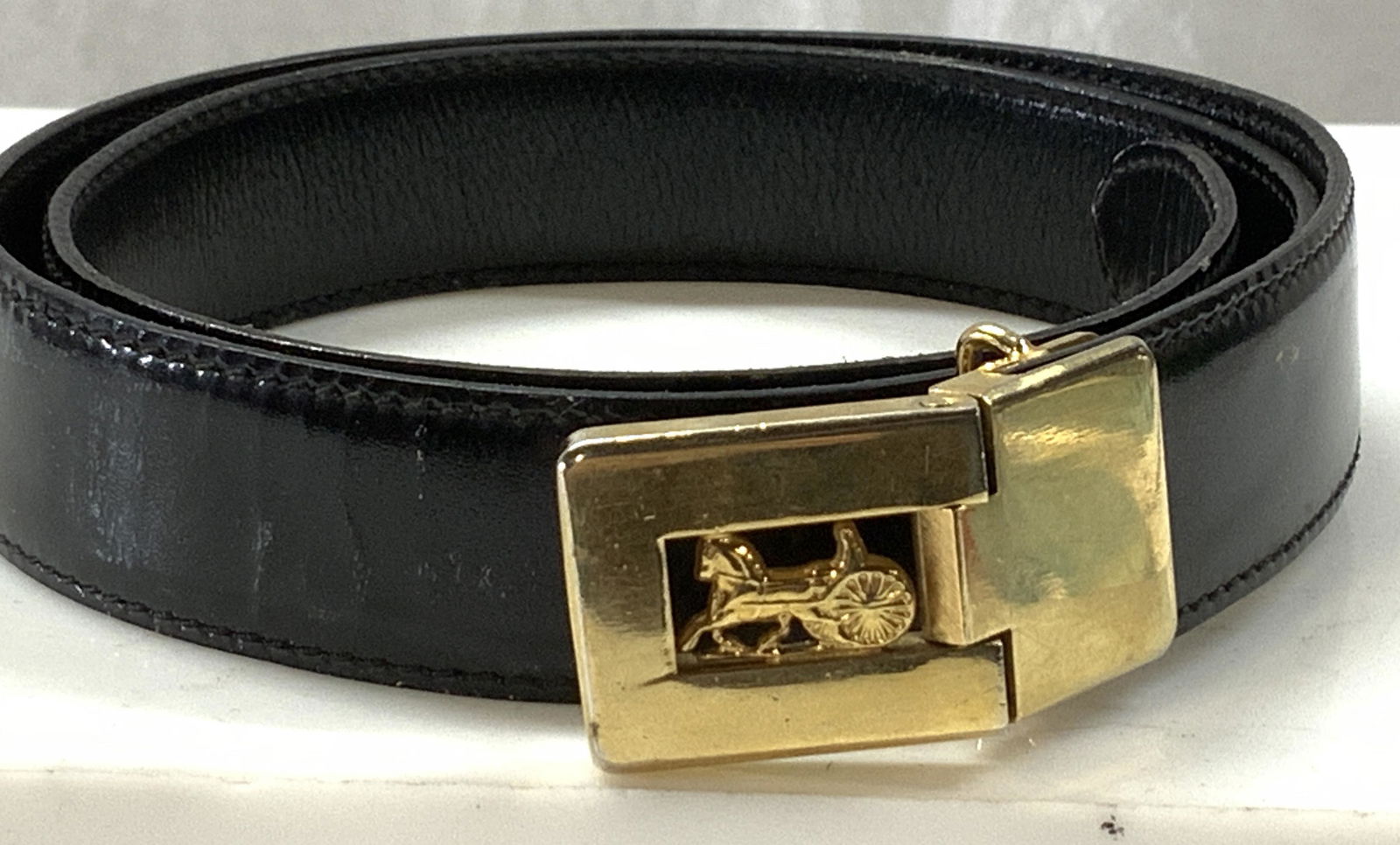CELINE Luxury Leather Belt w Logo Buckle,France: Ladies luxury Celine Black leather belt with brass horse buggy logo. Total length 34.5 in. last prong at 30 in. Belt measures 1 in wide.. light scrape marks consistent with wear. 3 luxury accessories,