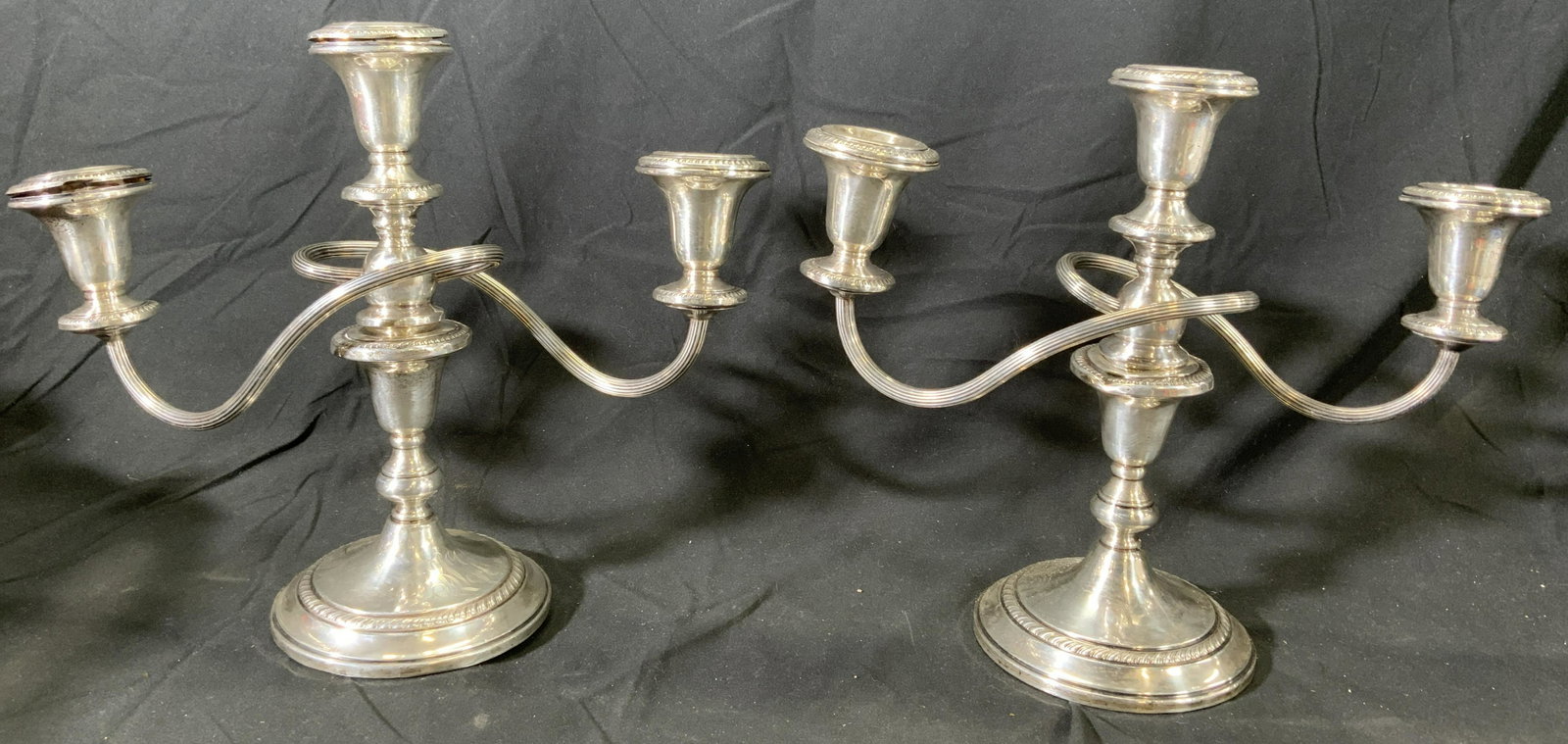 Pair HAMILTON STERLING Candelabra/Chamber Sticks: Pair of Hamilton sterling silver candelabras. Top arms are removable and convert into chamber sticks. Measure approx. 12.5 x 5 x 10.5 inches each. Surface wear to pieces consistent with exposure, some