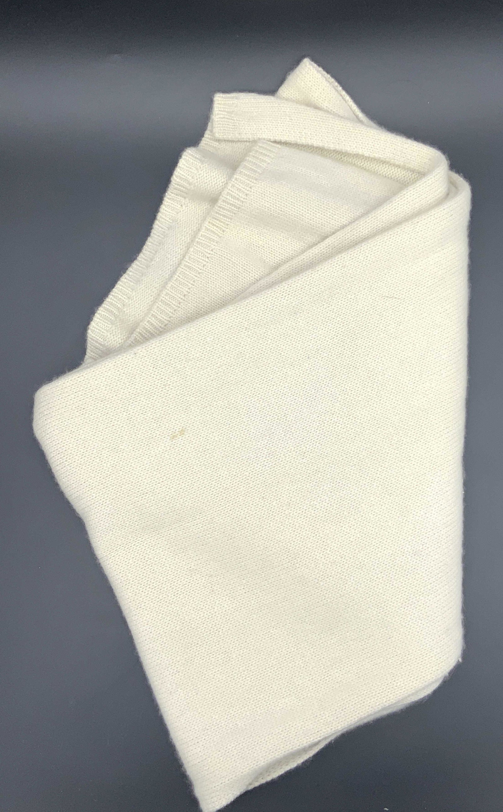 Off White TSE Knitted Cashmere Scarf: An off white knitted scarf, designer tag reads TSE, 100% Pure Cashmere. Approximately 86 inches long. Evident blemishes to scarf. TSE cashmere scarf, cashmere scarf, scarf, designer scarf, off white s