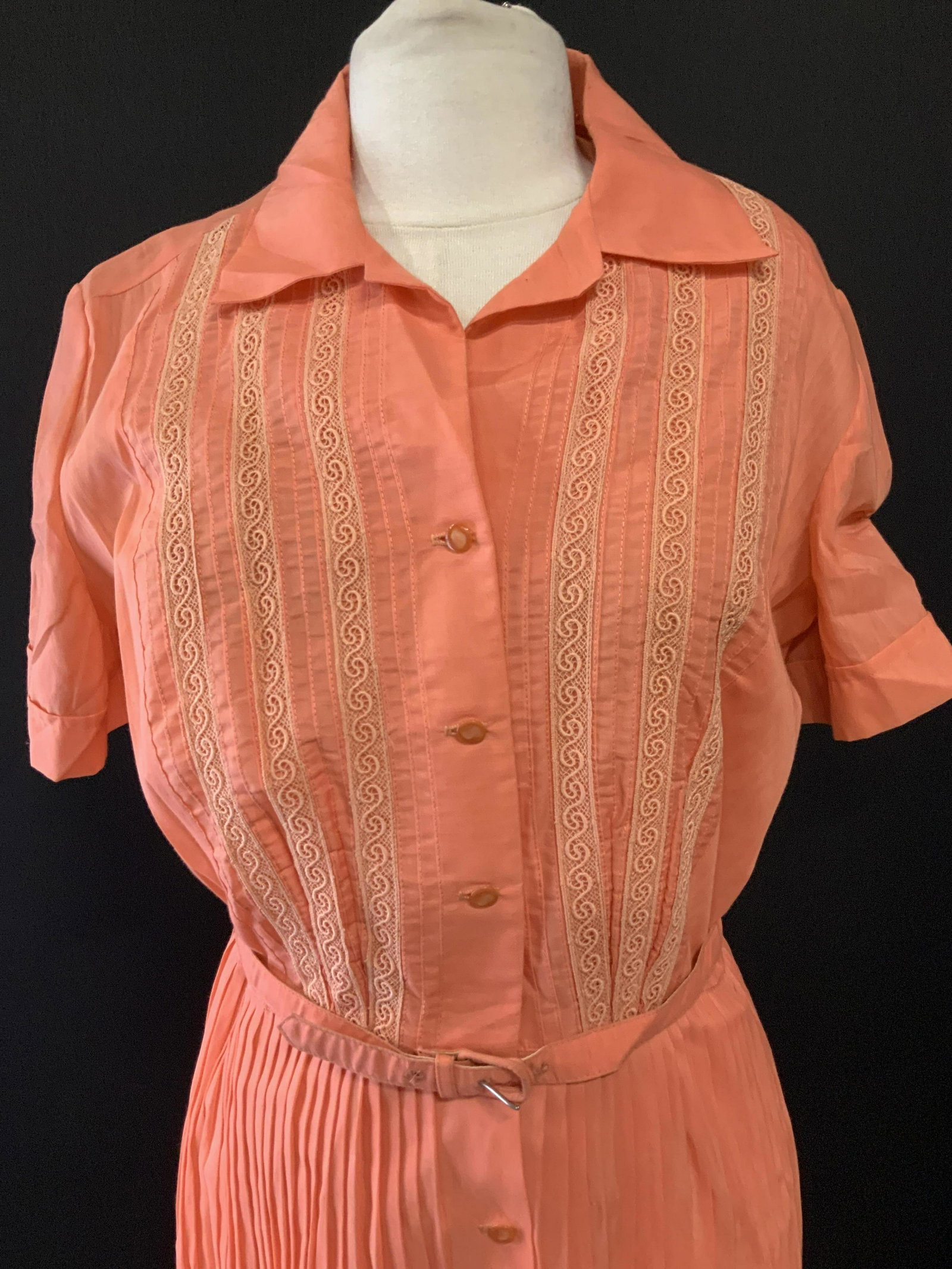 Palm Fashions Pleated Mid Century Dress + Belt: Coral pleated dress , button down in front from chest to above hem. Length 45 in long. Waist 28 in. Semi sheer fabric, possibly polyester. Labeled Palm Fashions Deland, FL. Thin buckle belt comes with