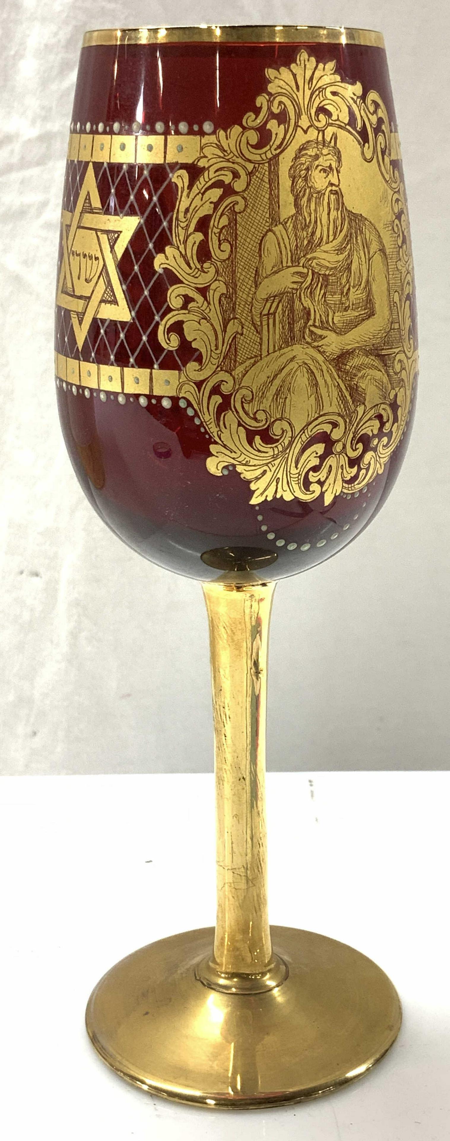 Ruby Red & Gilt Crystal Kiddish Cup: Hand painted gilt in bohemian Ruby red crystal glass. Moses and Star of David, and menorah motif. 8 in ht, 3 in. Width. 3 Crystal Ware, Ruby Red Bohemian Style Crystal Stemware, Kiddish Cup, Gilt Crys