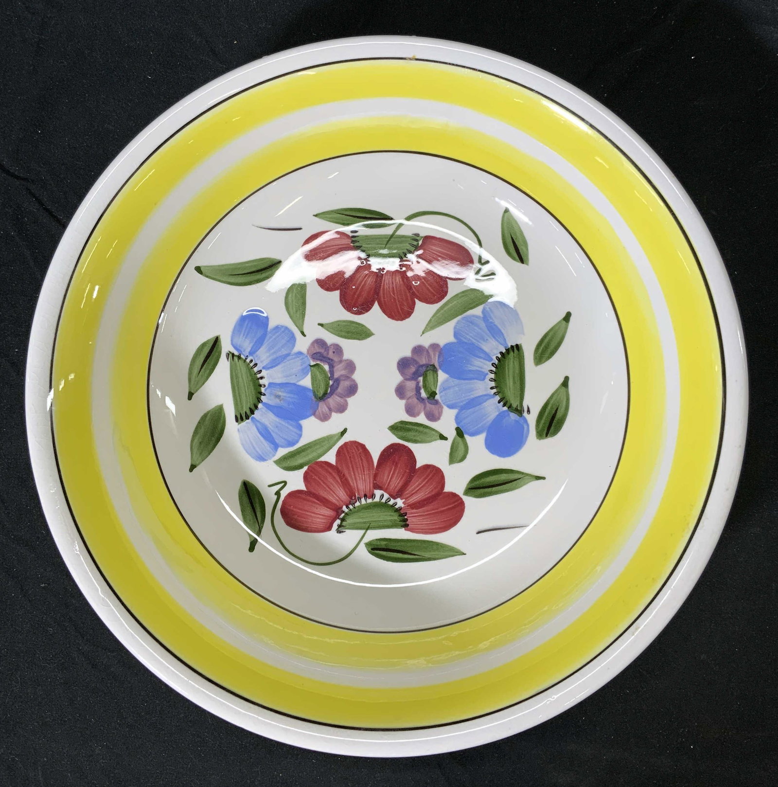 S.S. CROWN Ironstone Ware Floral Bowl, Japan: S.S. CROWN ironstone ware bowl with floral motif in hues of yellow, red, and blue. Marked S.S. CROWN JAPAN to underside. Measures approx. 11.25 inches diameter. Surface consistent with age, use, and e