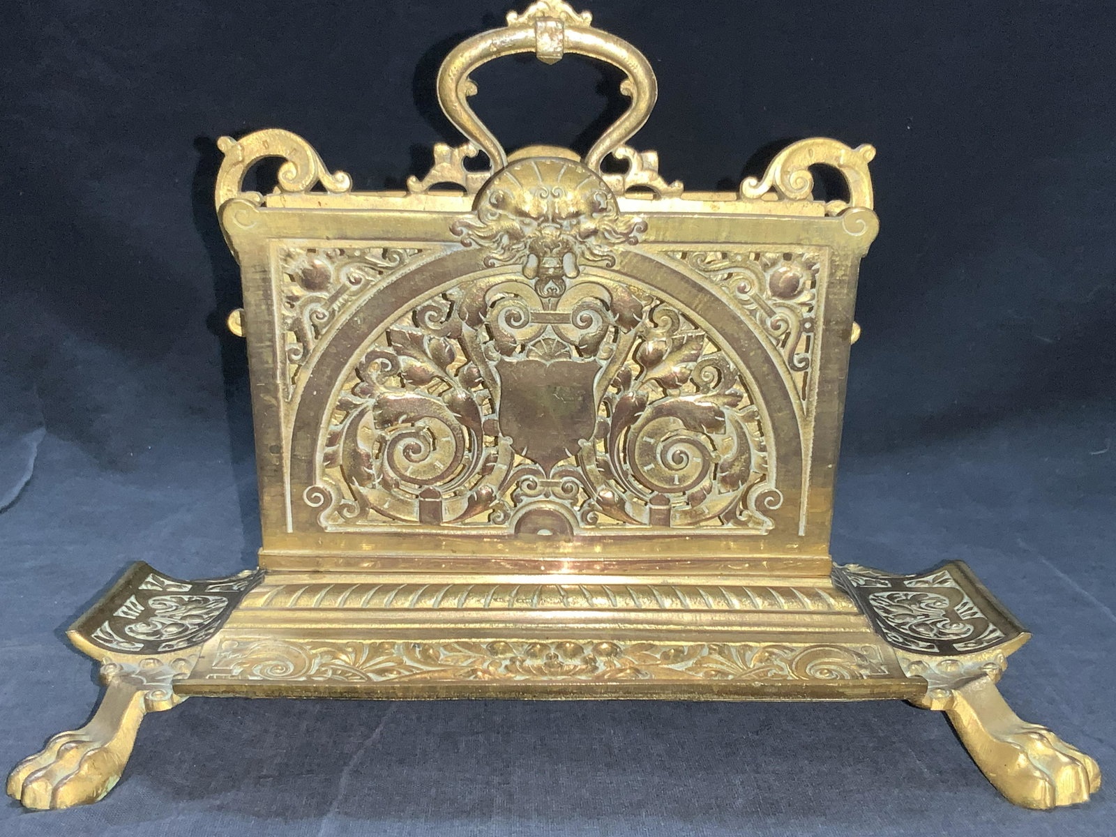 Vintage Brass Claw Foot Ornate Letter Holder: Vintage brass made letter holder with 2 slots, brass slots are cut with scroll designs with a lion style animal head on topside. Base of holder has wide curved rims, embossed with floral and scroll de