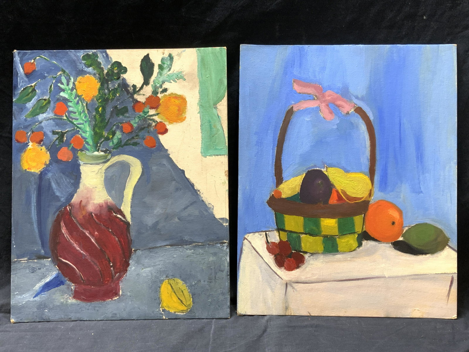Pair Acrylic on BoardStill Life Paintings: Pair Acrylic on Board Still Life Paintings, 1/2: subject shows a vessel with flowers in it and half a lemon, 2/2: shows a basket with fruits, verso inscribed Nikki Lamdsman, no frames, surface wear, e
