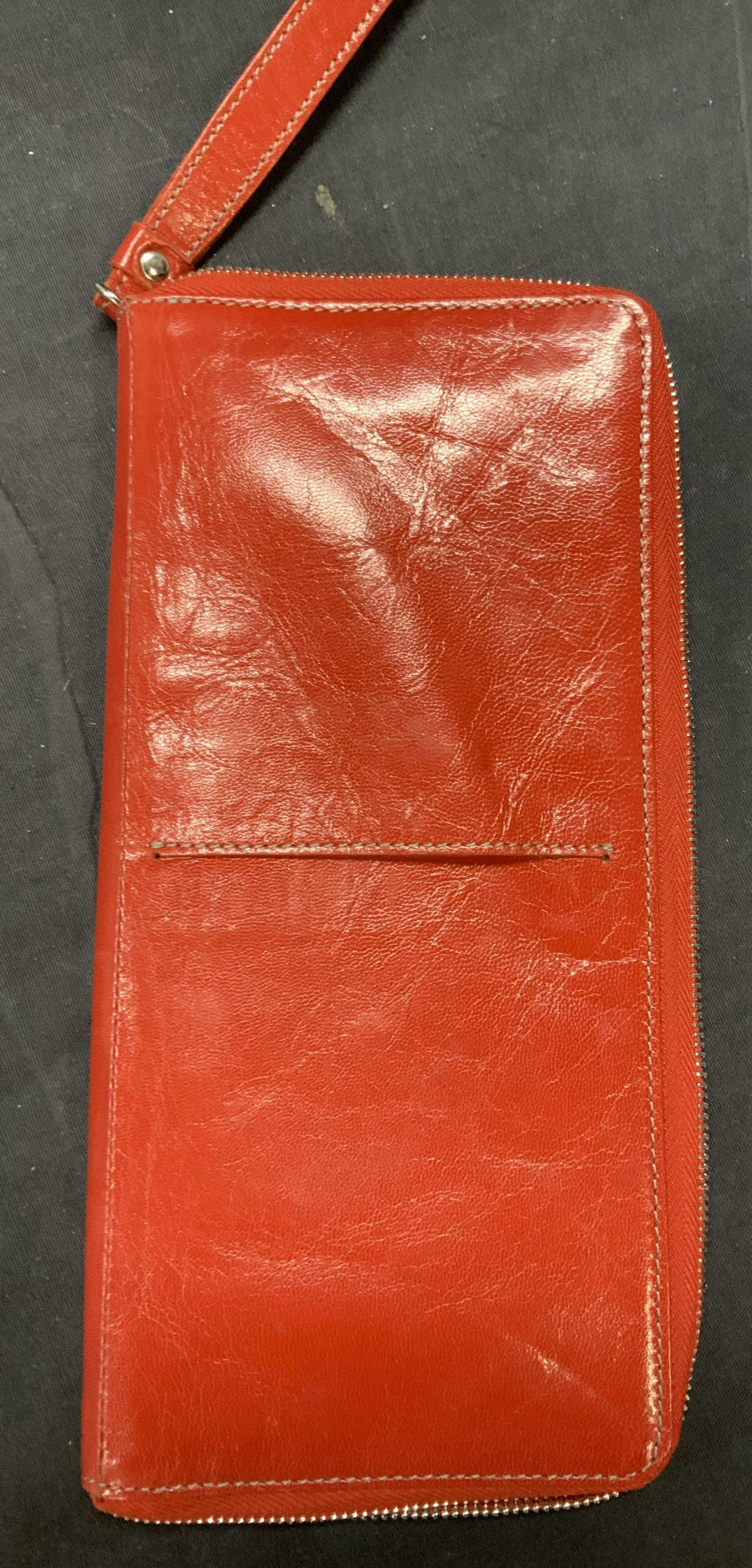 Tusk Leather Passport/ CC Holder Wristlet: TUSK red leather wristlet for travel; holds passport in front and inside, multiple credit cards, ID, and Paper money. Even has a SIM card slot. Zippered closure. Measures 9.5 x 5 in. Impressed with ha