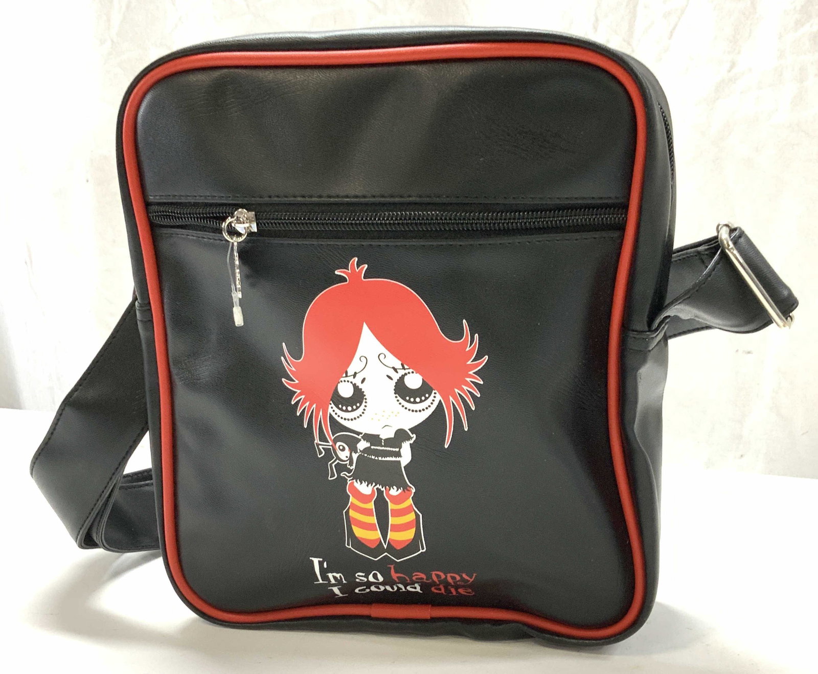 RUBY GLOOM Crossbody Bag, New: Ruby Gloom Pop Fashion Crossbody / Shoulder bag with character Ruby Gloom on front with phrase Im So Happy I Could Die. Bad measures 10 x 9 in. Front zippered pocket , backside skull and bone pattern.