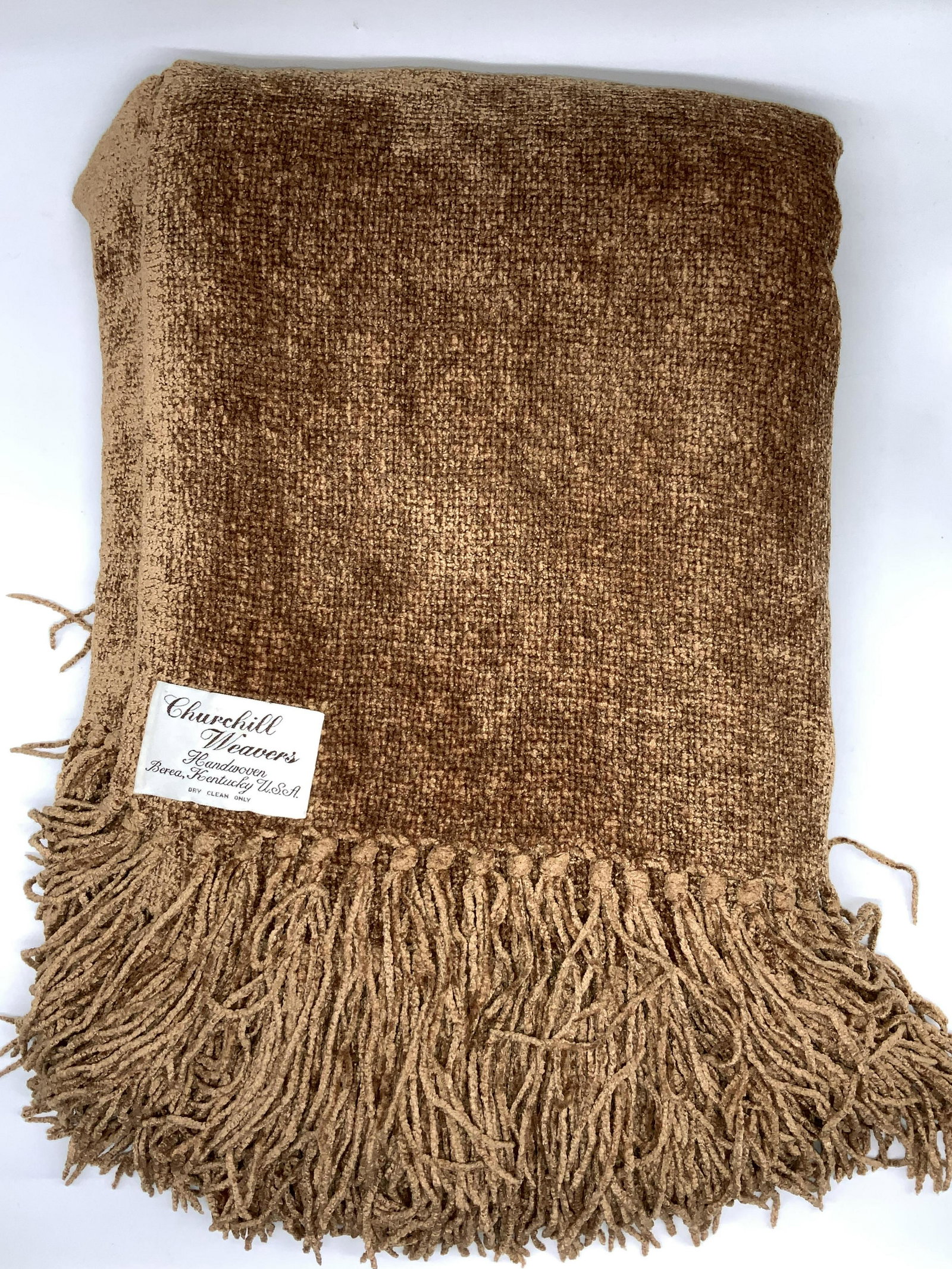 Churchill Weavers Handwoven Chenille Throw Blanket: Signed designer label sewn to chenille throw. Label reads Churchill Weavers Handwoven Berea, Kentucky USA. Measures 50 x 69 in. A Rusty orange tone. end tassels. Dry clean. Heavy weight. Property of M