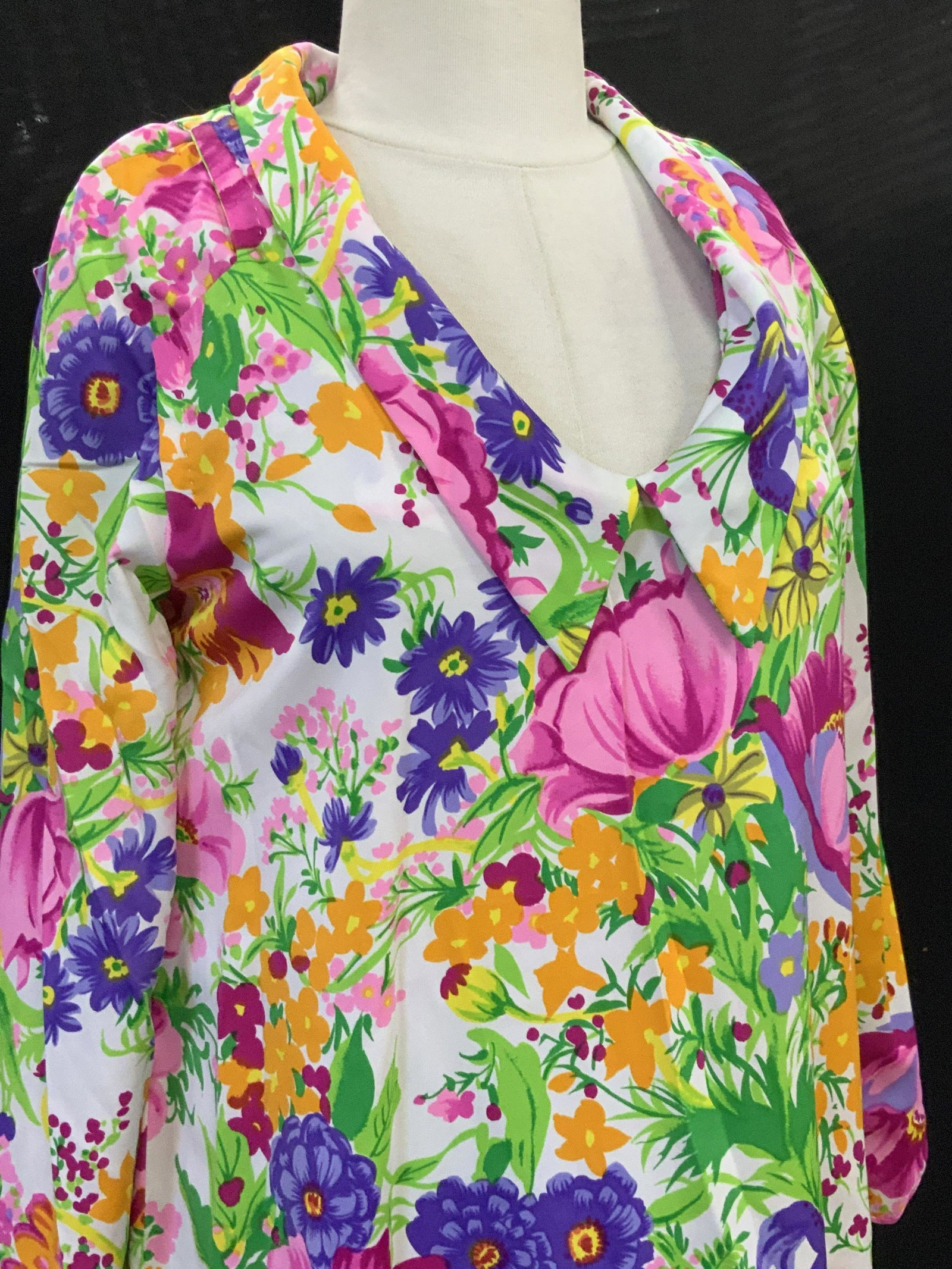 Vintage Floral Muumuu Dress with Flared Sleeves: Multi colored vintage muumuu dress with florals, flared long sleeves, side slits. Possibly a polyester fabric , lightweight and breathable. Waist 42 in. 48 in. Long. This dress is hand made with machi