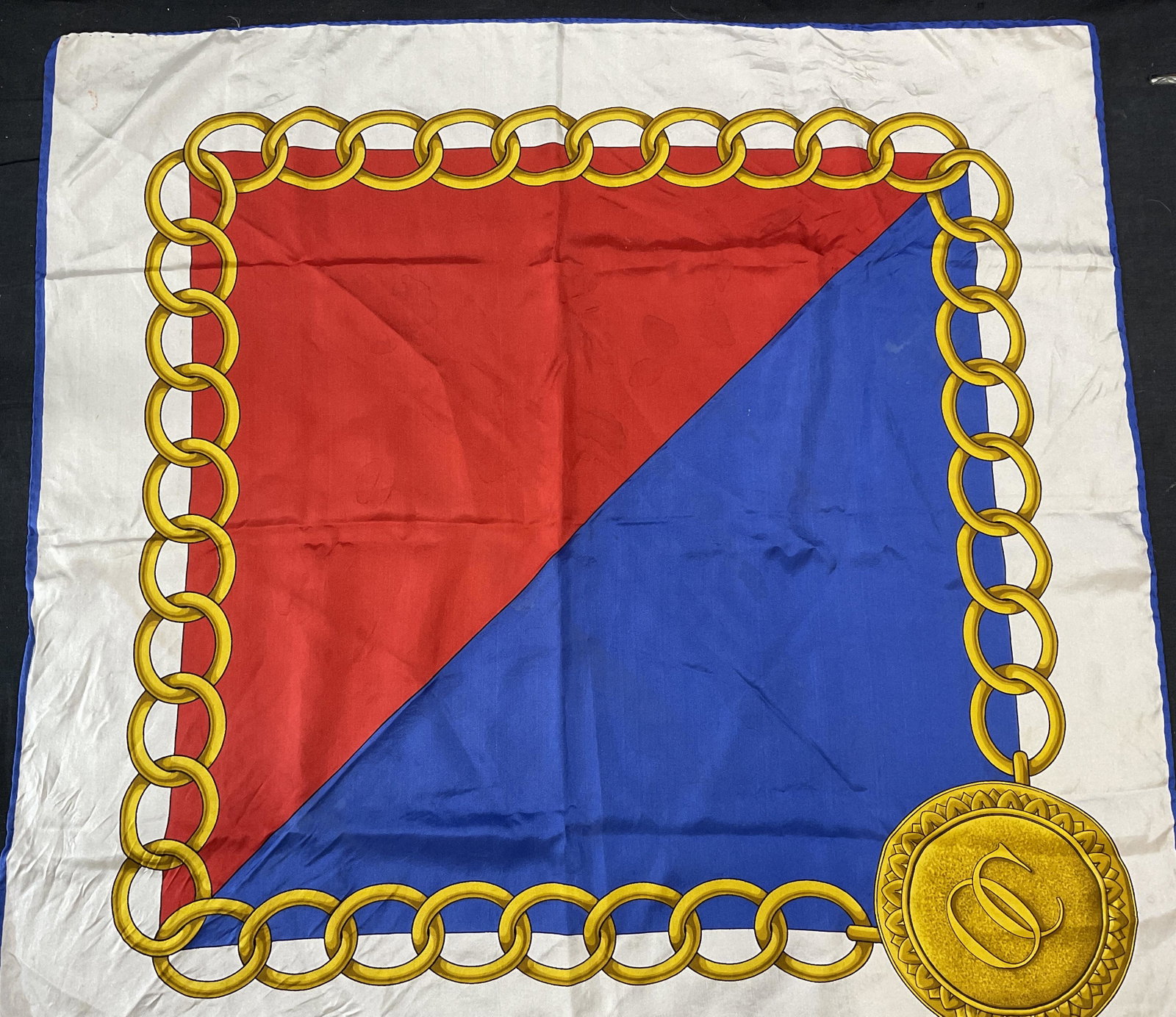 Oleg Cassini Hand Rolled Silk Scarf, ITALY: Oleg Cassini Hand Rolled Silk Scarf. Measures approx 27 x 26 inches. Minor stains throughout scarf. Label reads made in Italy 100% all silk. Surface wear to piece. Oleg Cassini Scarf, Oleg Cassini sil