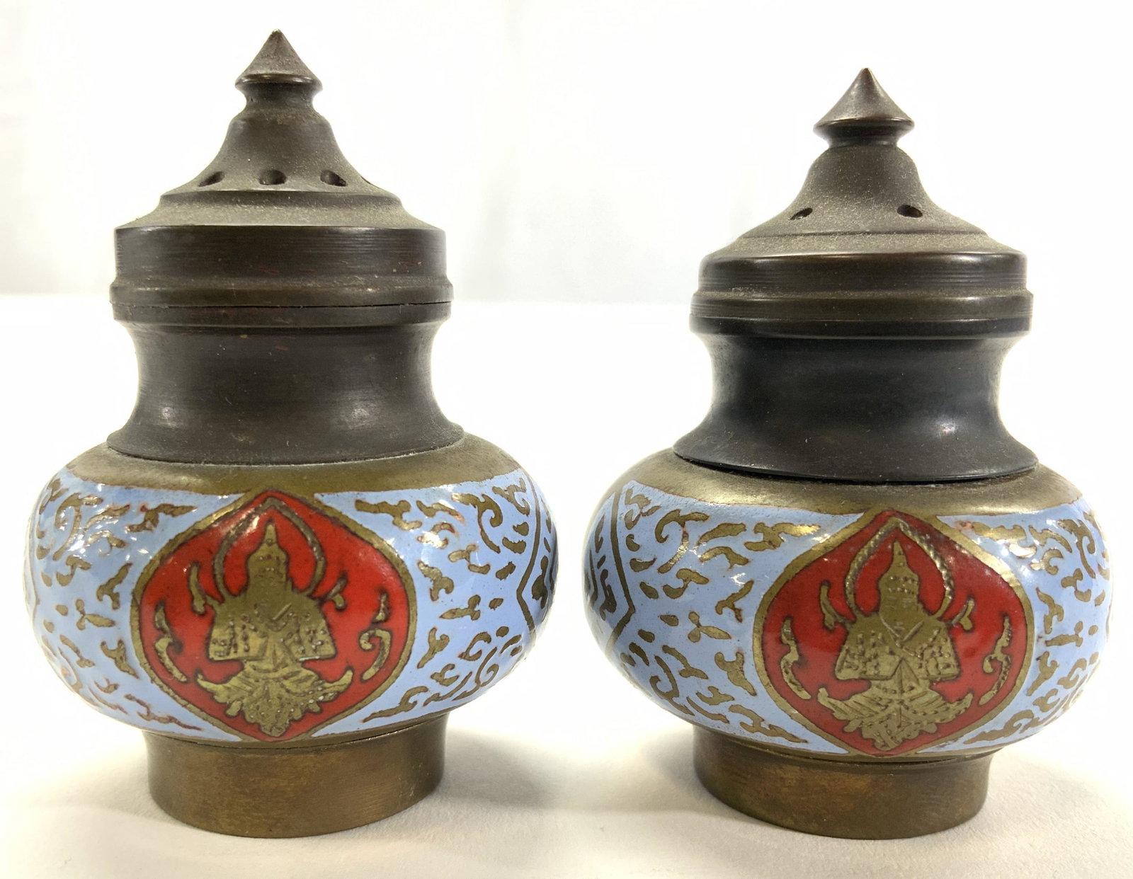Painted Asian Salt & Pepper Shakers: Lot includes 1 salt and 1 pepper shaker. Each appears to be hand painted with powder blue & red detail. Shakers are gold toned and appear to be brass. Each measures approx 2.25 inches tall 1.5 inches 