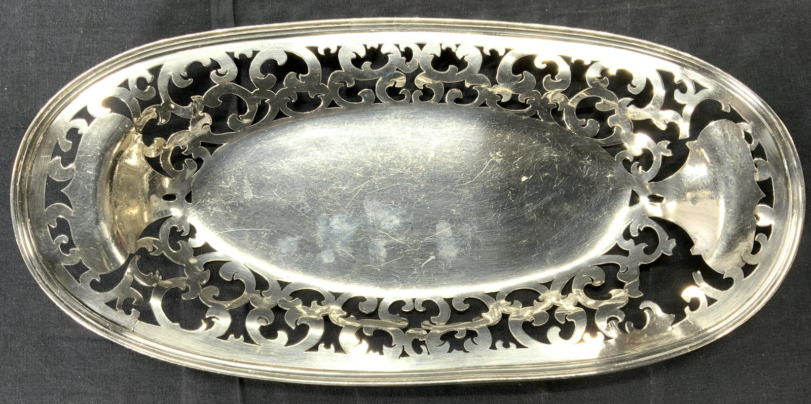 M B CO EP WM Pierced Oval Dish: Dis is inscribed M B CO EP WM HAMILTON CANADA 1764. Piece is silver toned appears to be electroplated . Dish has scroll shaped pierced detail. Piece measures approx 13 inches long 6.5 inches wide. Dis