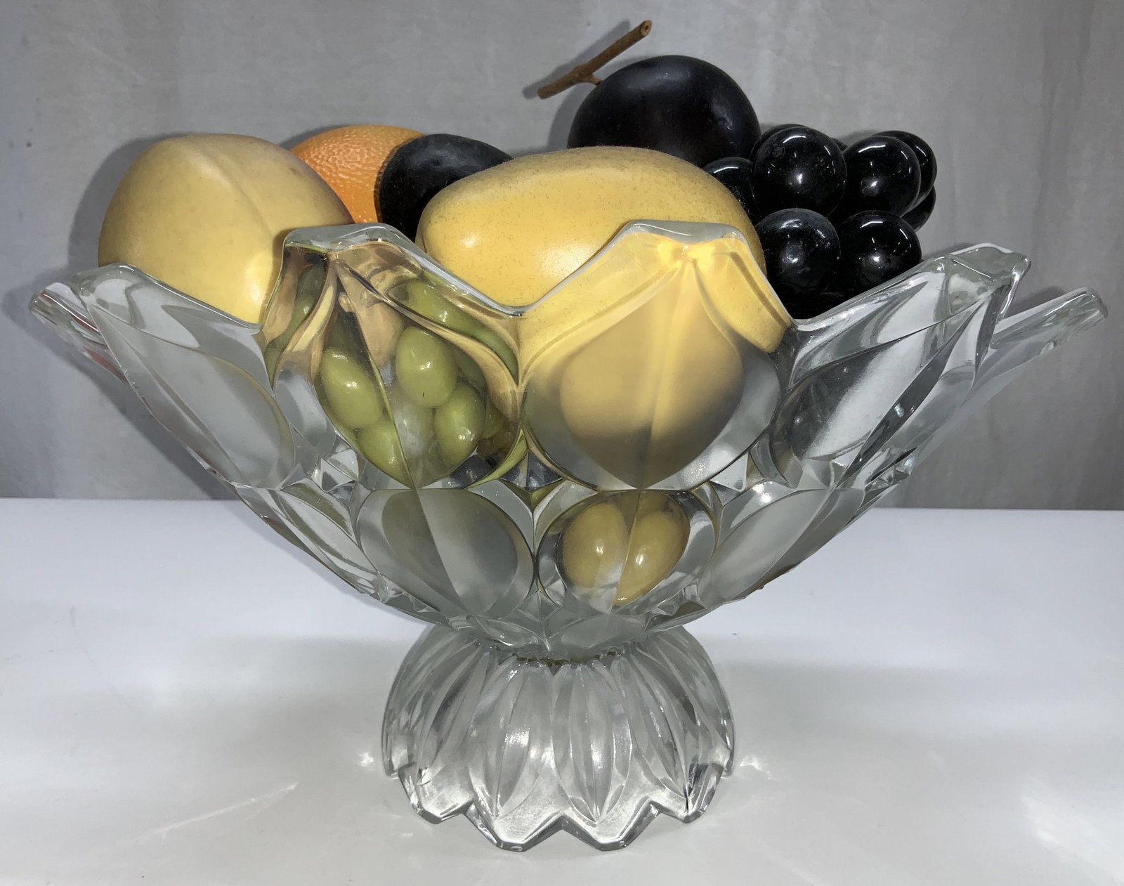 Vtg Footed Glass Bowl with Faux Fruit: Thick walled vintage molded glass bowl/ fruit bowl with decorative faux fruit- green and black grape bunches, fig, plum, orange, pear, peach. Bowl measures 11.25 x 8.5 in ( L x W), Ht 7 in. Centerpiec