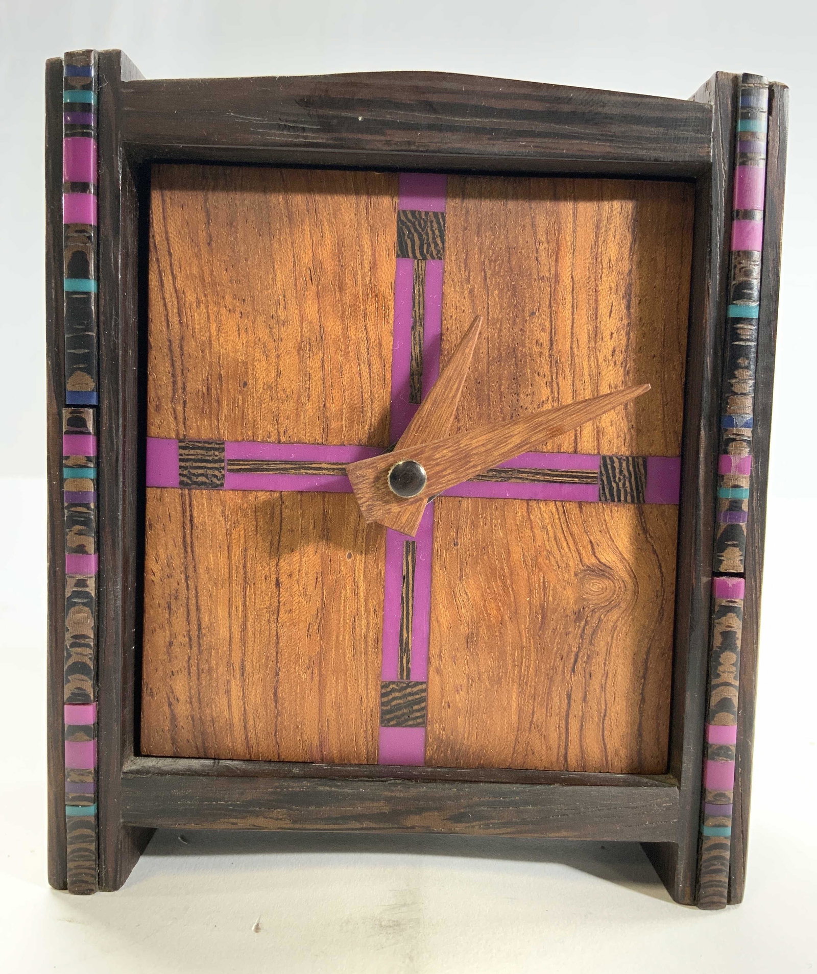 Wood Veneer Desktop Clock: Clock approx to be wooden possibly veneer. Piece light & dark brown tones with multi toned stripe detail. Clock measures approx 4.5 inches tall 4 inches wide 2 inches deep. Clock, desktop clock, woode