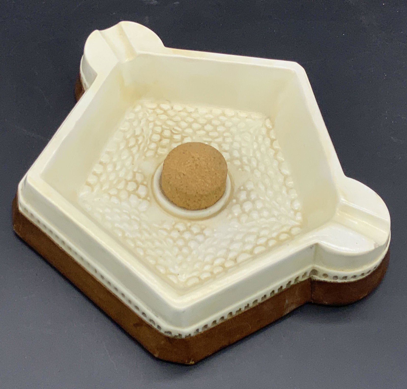 Vintage Leather & Cork Mid Century Ashtray: A vintage mid century style ashtray / trinket dish comprised of leather, cork, and composite materials. Textured interior. Measures approx 2H x 8.5W in. Some losses and discoloration to piece. Ashtray