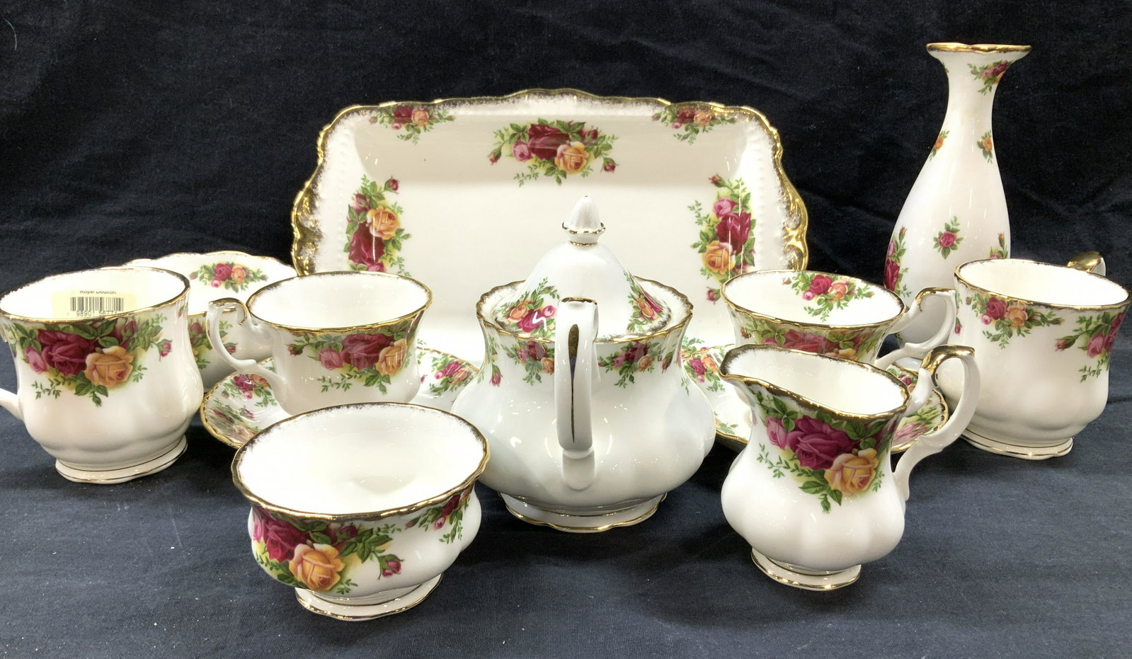 Set 12 Royal Albert Porcelain Tableware: Royal Albert Olde Country Roses Fine Bone Chinaware. White China with hand painted pink and orange roses, gilt rims. Includes bud vase 7.5 in ht. Serving tray 12 x 7 in. Tea pot, creamer, sugar bowl, 