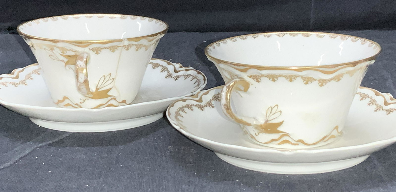 HAVILND & Co LIMOGES France Tea Cups & Saucers, 2: 2 pair of white porcelain and gilt Haviland & Co Limoges France, signed. Fine bone chinaware . Saucers measure app 5 in. Tea cups measure 1.75 in ht. Crack and chip to one cup. Haviland & Co Limoges F
