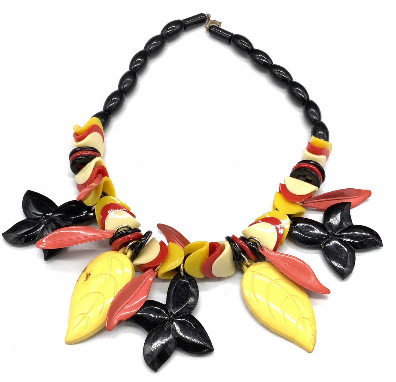 Vintage Leaf Motif Beaded Necklace, Jewelry: A vintage beaded necklace comprised of etched leaf form beads, flower form beads, oval beads, and more. C-spring clasp. Necklace length approx 18 inches. Pieces are crafted from a resinous or composit