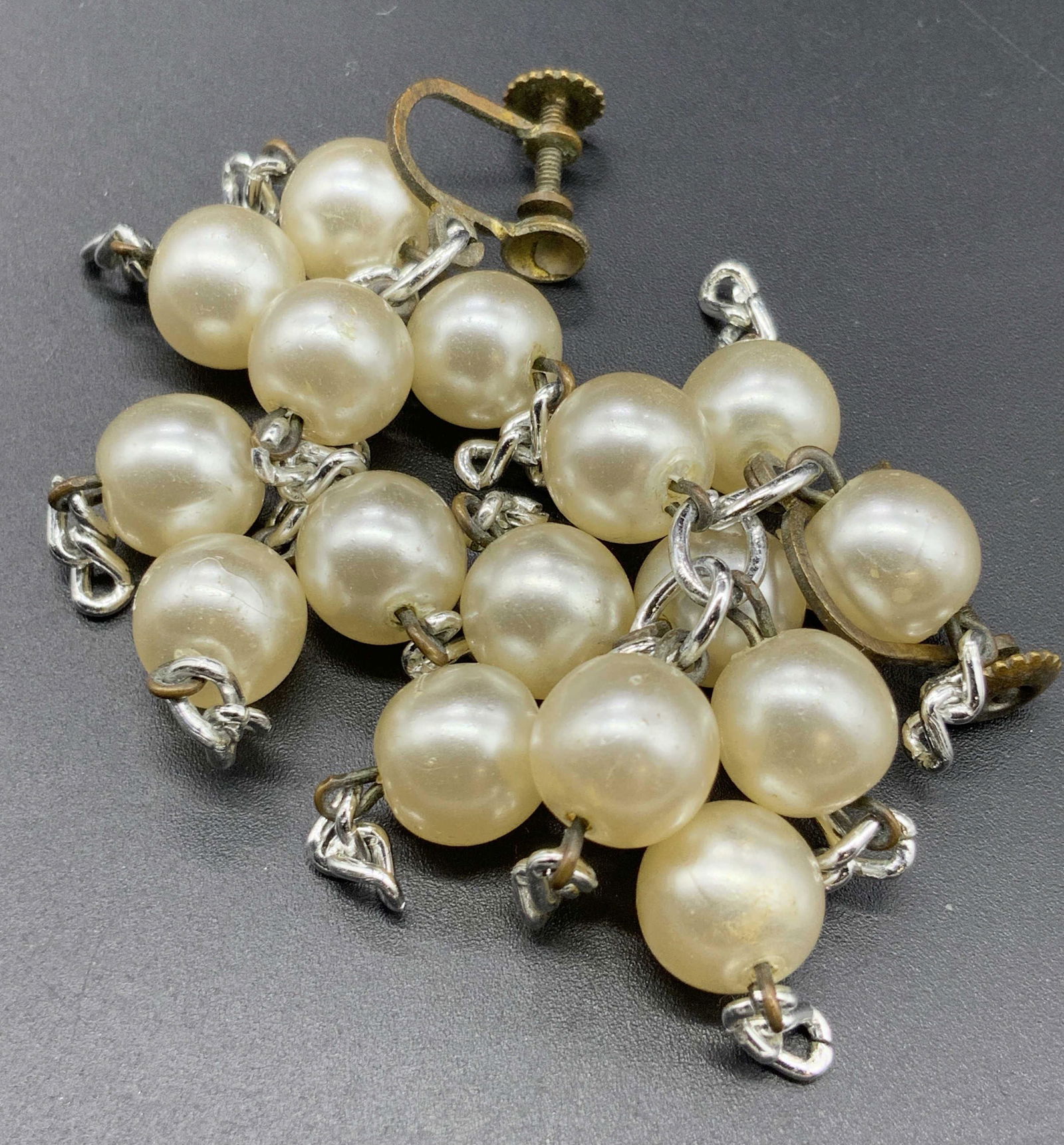 Vintage Dangling Pearlescent Bead Cluster Earrings: Vintage dangling pearlescent beaded cluster earrings. Twist back closures. Measures approx 2L x 1W in. Some surface wear consistent with age and use. Vintage jewelry, Vintage accessories, Fashion Jewe