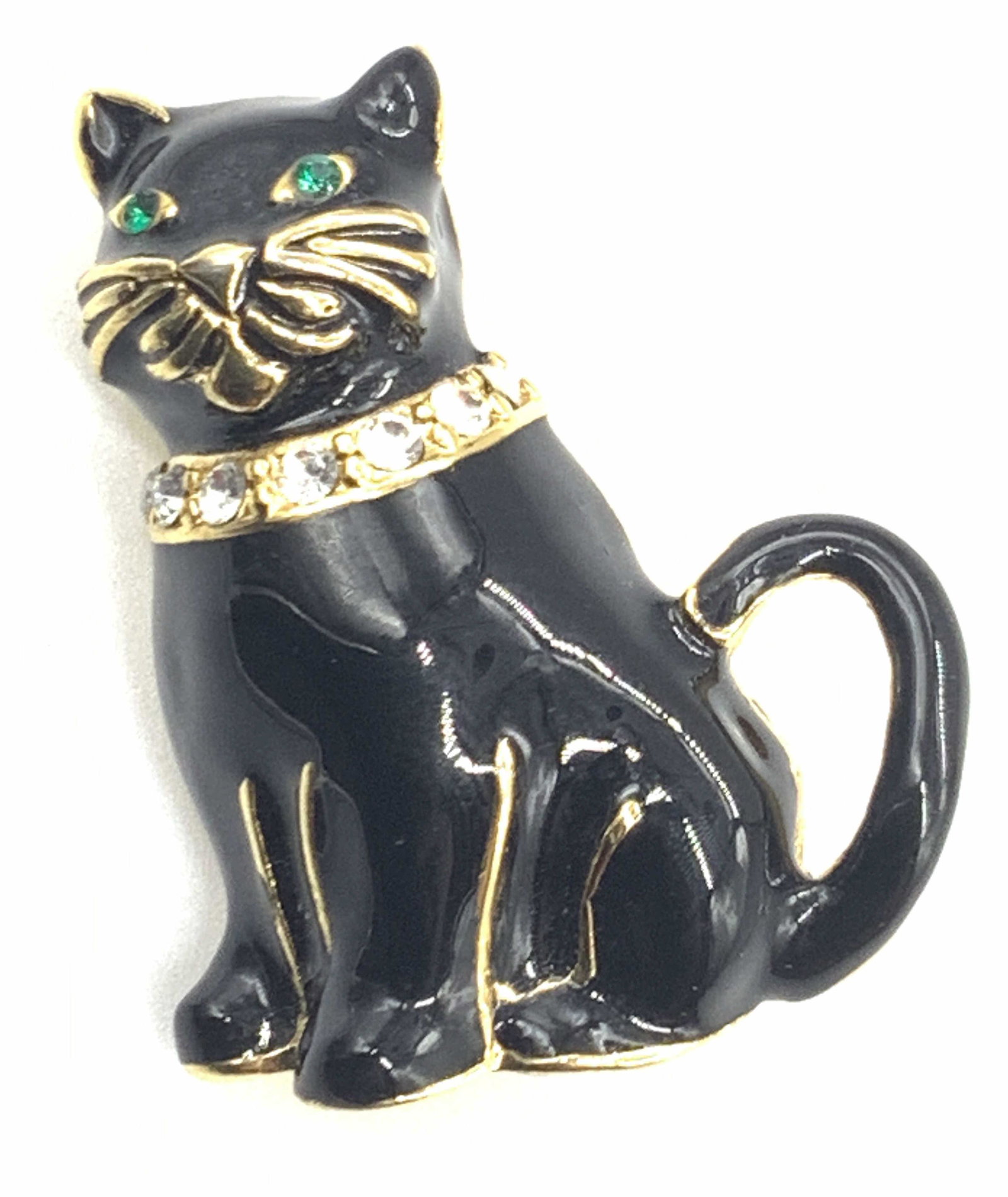 MONET Signed Black Cat Brooch: Signed on backside of brooch, Monet. Brooch resembles a black enamel cat with a faceted white rhinestone collar and green stone eyes, approximately 1.25 inches long. Singed Monet brooches, Monet Colle