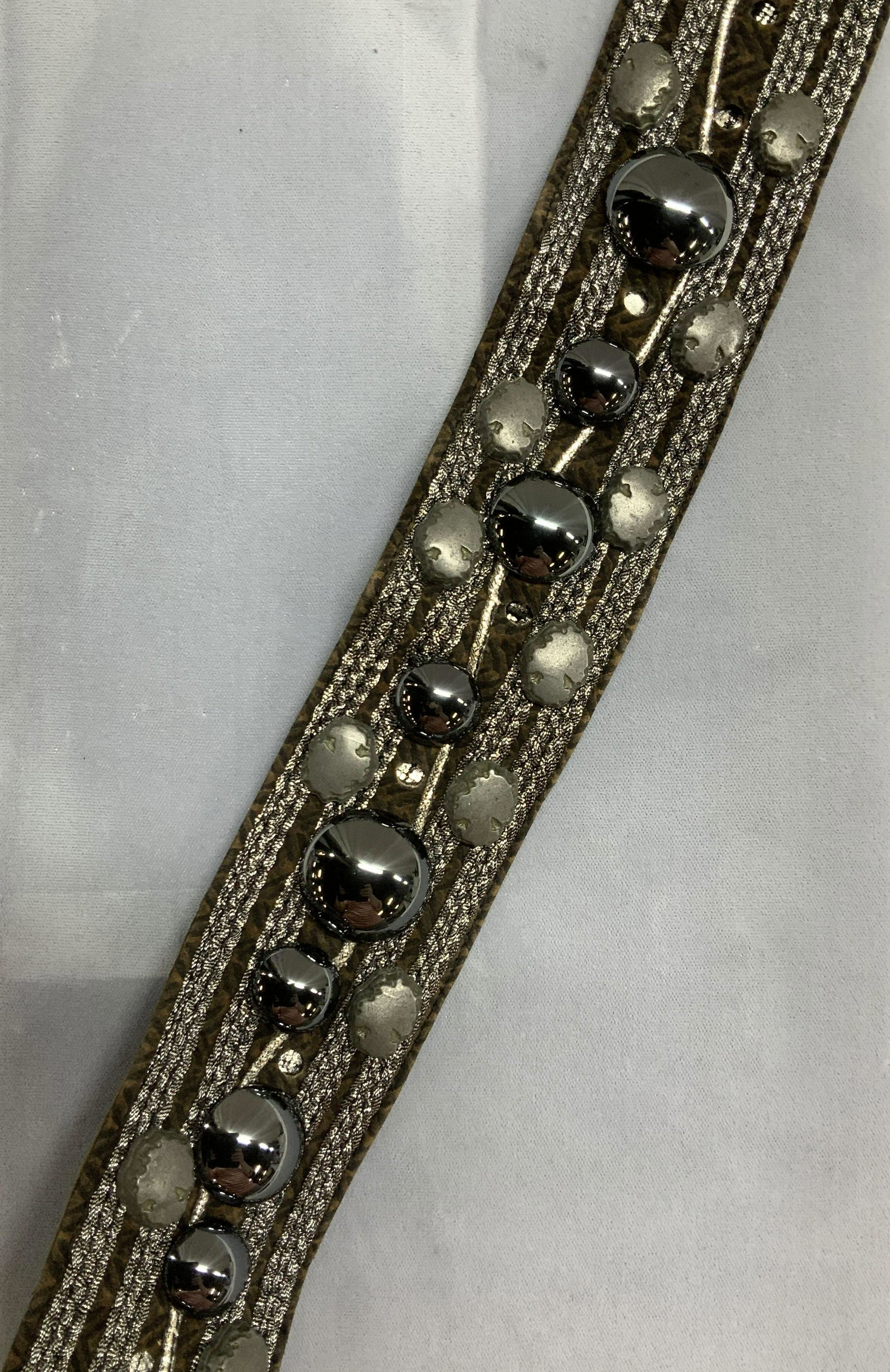 Unlabeled Leather Prong Belt w Large Studs: Ladies leather and suede belt, exterior decorated with Chevron pattern with silver metallic ribbon, gunmetal toned metal cabochon studs and silver toned toned organic metal nuggets. 6 prong holes at 3