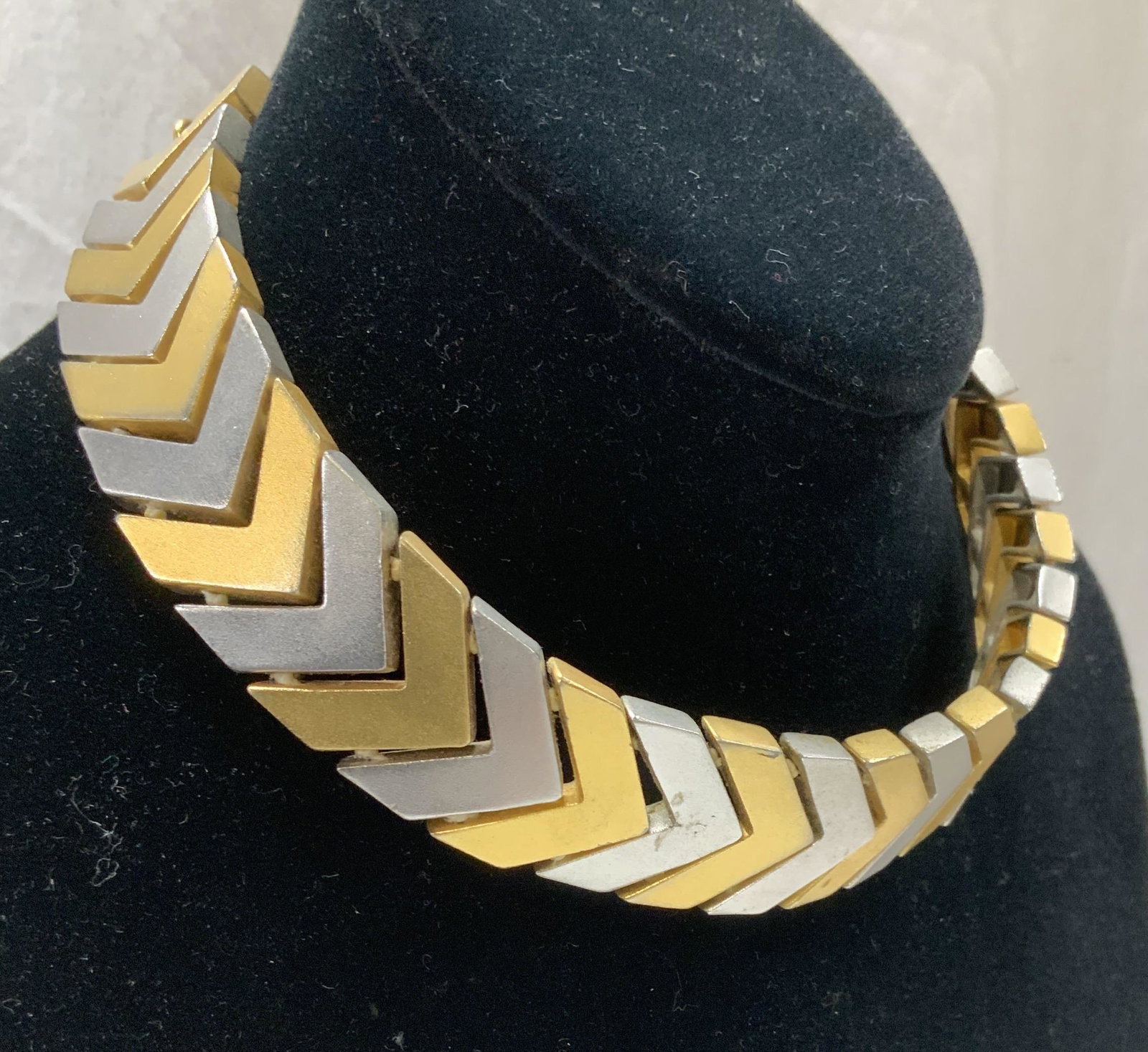 Two Tone Chevron Choker Weighted Metal Necklace: Brushed metal in silver and gold tone, alternating colors with Chevron links. 7/8 in wide. Total length 15 in. Weighted Metal and sits along neckline like a thick bone chain. Light wear. 3 Chunky jewe