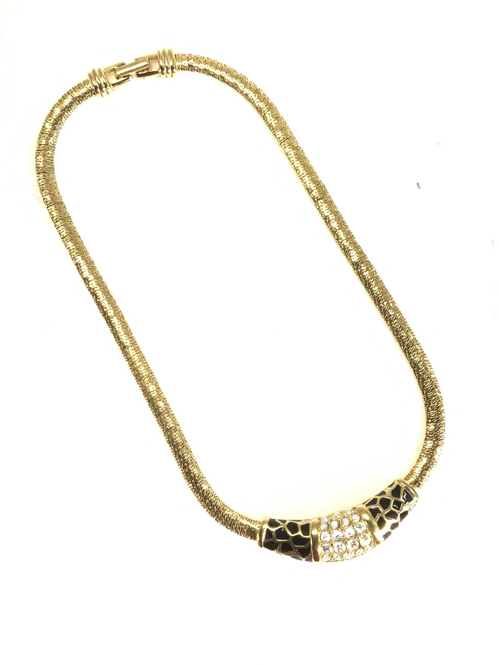 SWAROVSKI GoldTone Animal Print & Crystal Choker: Signed Vintage SWAROVSKI Choker necklace , diamond cut gold tone flat bone style necklace with black enamel animal print and crystal accent. Chain measures 16. In . Secure clasp. 3 Luxury jewelry, SWA