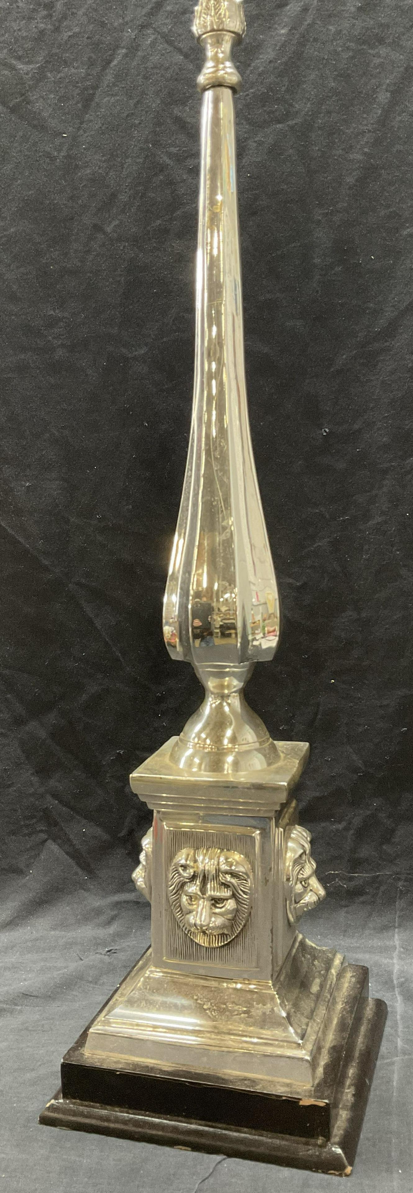 Decorative Lion Head White Metal Obelisk: Decorative Lion Head White Metal Obelisk. Significant weight to piece. Measures approx 28 x 7.5 x 7 inches. Some surface wear to piece, (see photos). Lion head relief towards bottoms of piece. Base is