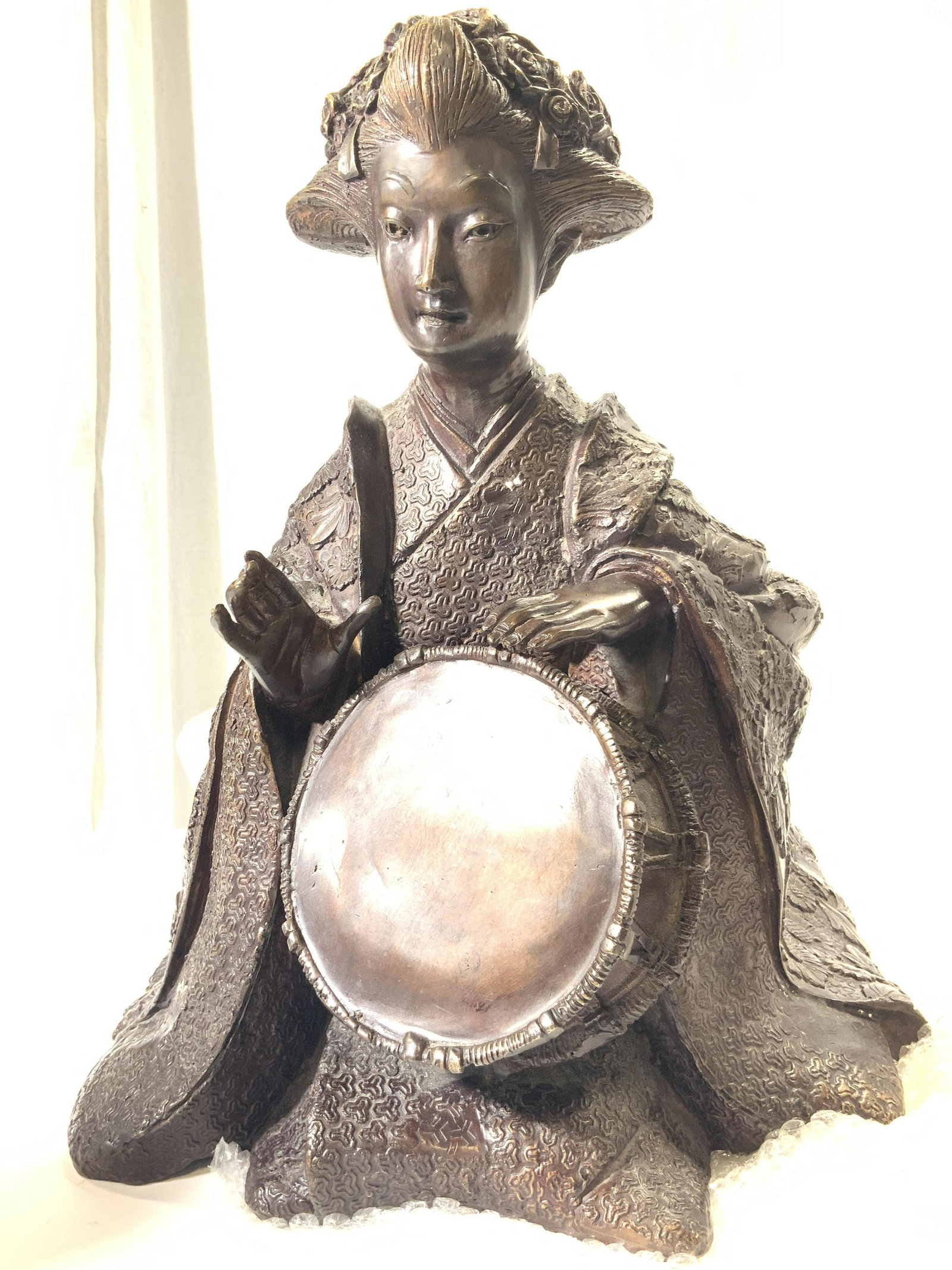 Vintage Cast Bronze Japanese Geisha Sculpture: Vintage Weighted cast bronze sculpture of a Japanese geisha. Sculpture depicts a kneeling geisha playing a drum, with hands in position to play. Geisha is embossed with various textile pattern in robe
