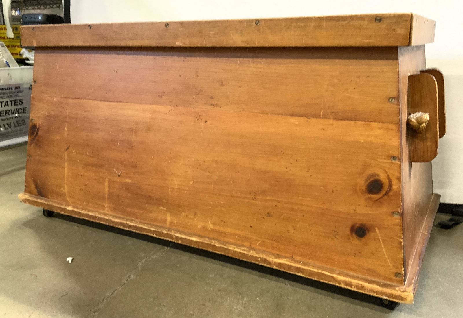 Vintage Wooden Chest On Casters W Handles: Chest is vintage and wooden, possibly antique. Piece sits on 4 casters. Chest has rope handles. Piece appears to possibly be hand crafted. Chest measures approx 35 inches long 18 inches tall 19 inches