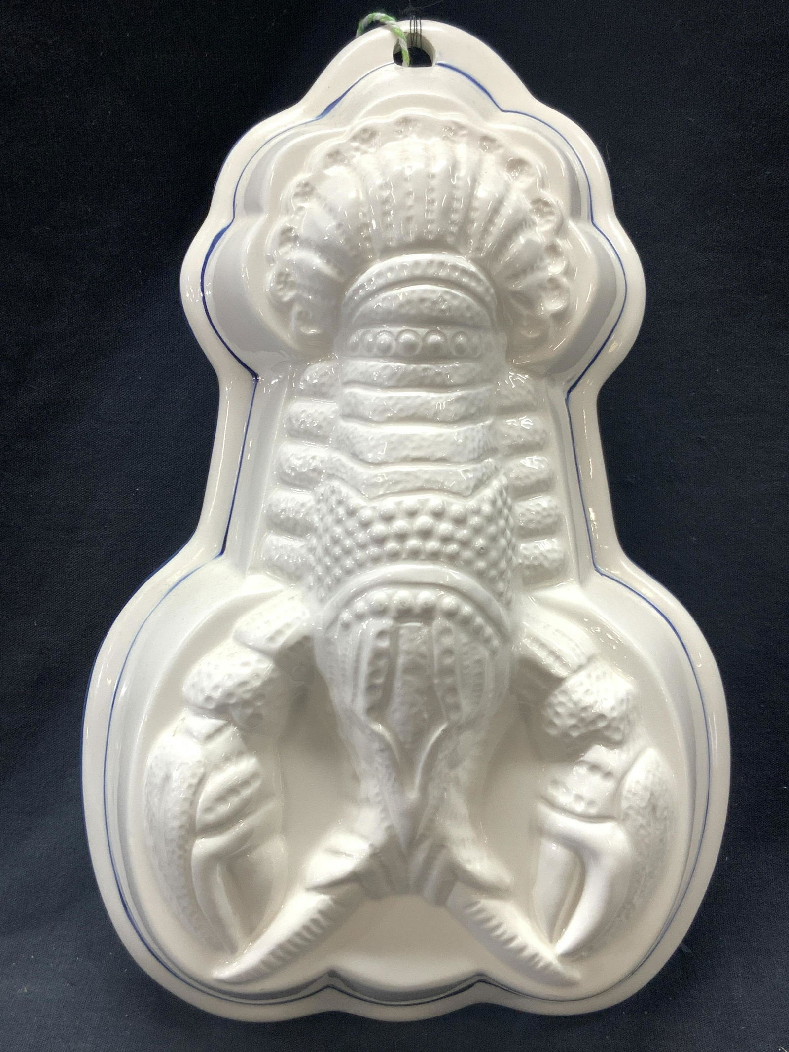 Hand Painted Ceramic Lobster Mold: Vintage hand painted ceramic made lobster mold, glazed in white with painted blue rim. Hanging hole on end of lobster tail. Approximately 11 inches tall and 10 inches wide. Minor chip to edge and loss