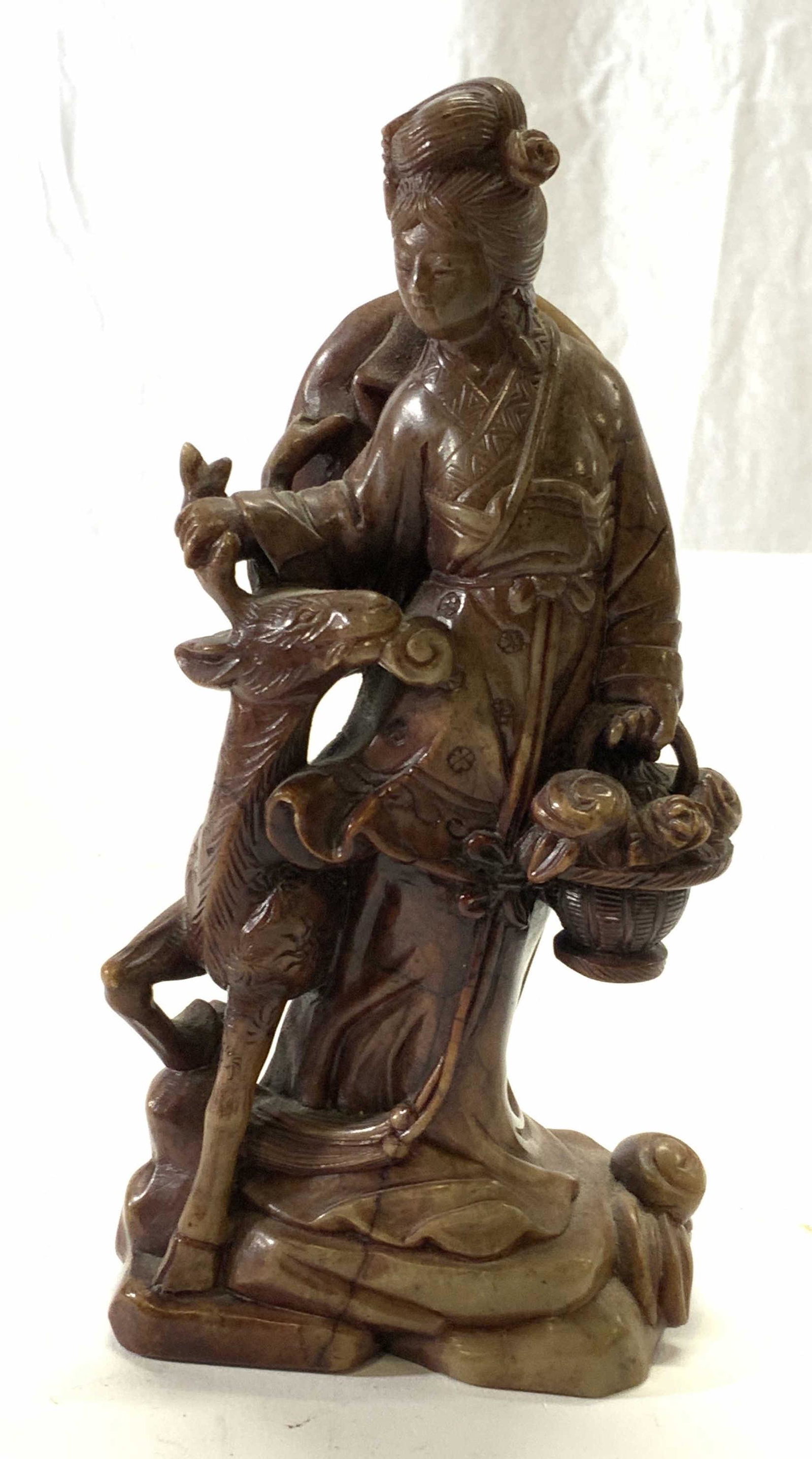 Carved Natural Stone Asian Figural Goddess: Carved natural stone, possibly Quartz, Asian goddess Figural with stag. Measures approx. 3 x 1.75 x 6 inches. Some wear to surface consistent with exposure. Piece is weighted. Asian Figural, Asian god