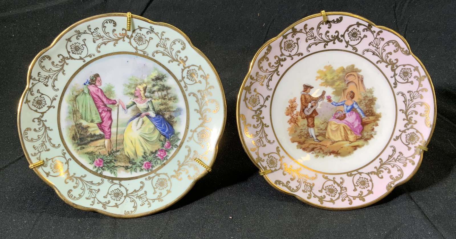 Set 2 Antique LIMOGES Gilt Porcelain Plates FRANCE: Set of 2 antique Limoges France porcelain plates, Hand painted with gilt decoration and figural motifs to center. Trademarked to undersides. Includes plate stands. Plates measure approx, 5 inches diam